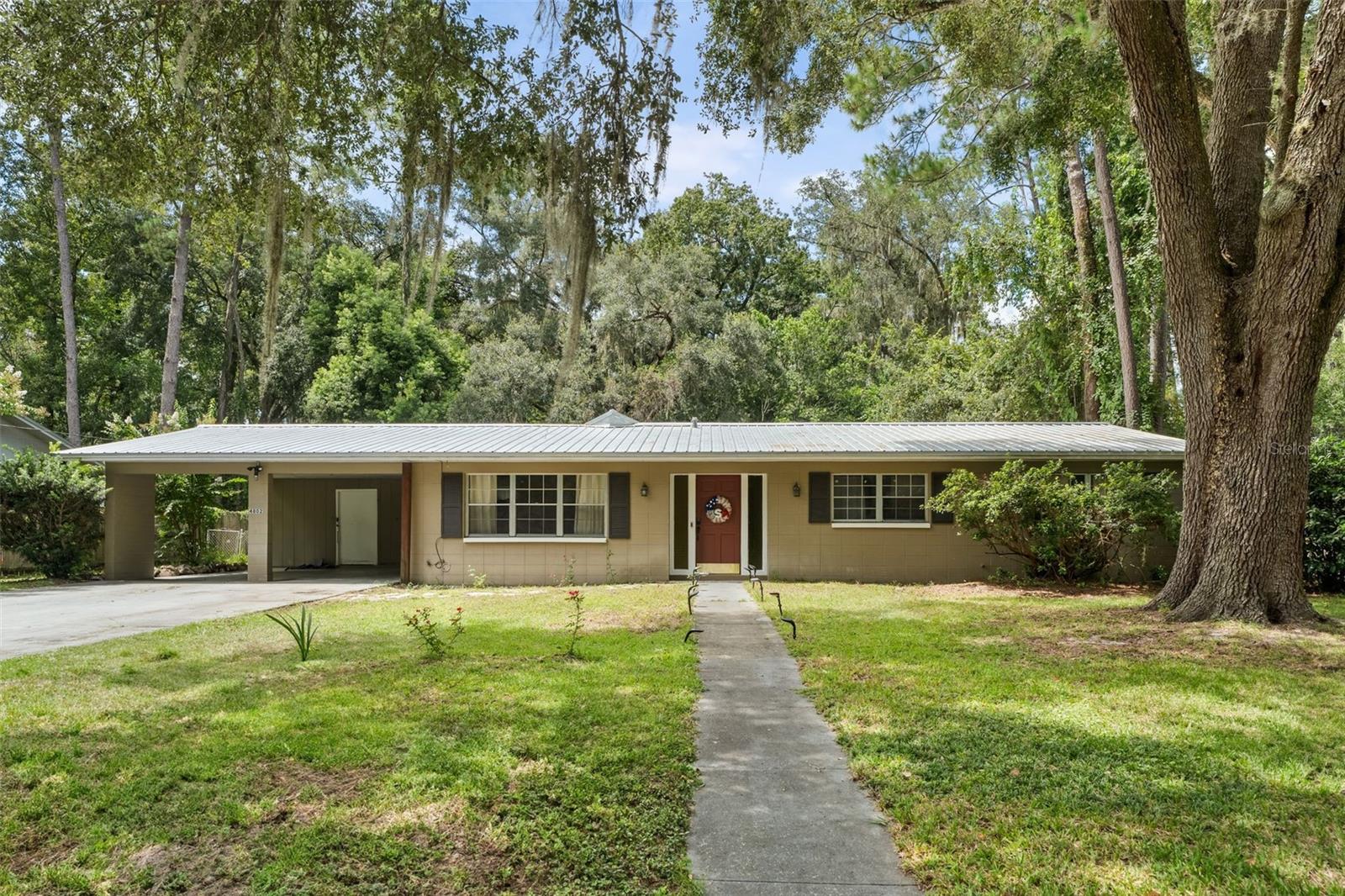 Walk to YMCA and a short drive to the University of Florida, UF Health and the VA from this centrally-located Northwood concrete block-home with NO HOA, 2019 metal roof, 2014 AC, 2019 water heater, 2025 fridge, 2025 kitchen stainless-steel kitchen sink. Features 3 bedrooms, 2 baths, formal living and dining and a massive family room that could be your game room and office or work out room, Possibilities are endless when you have the square footage! 1700 sq ft heated & cooled and 2200 sq ft under roof, spacious carport and generous driveway for all your other toys! Set on almost a quarter acre of land and priced under 300K! Both bathrooms have been updated, vinyl floors throughout are other features. Call now to view this home!