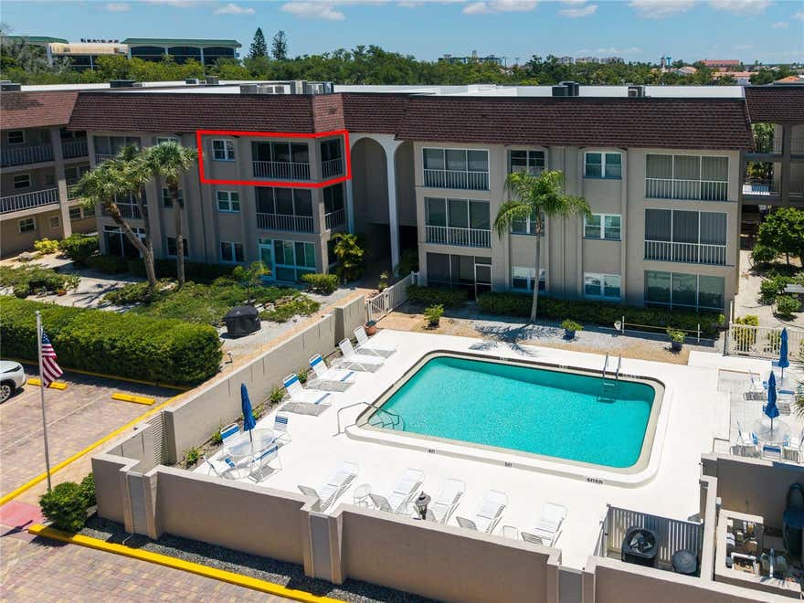 LOCATION!  LOCATION!  LOCATION!  MOVE-IN READY!  Welcome to Venice Park, a 55+ condominium community on Venice Island where units rarely come up for sale.  This is island living at its best, where you can walk two blocks to the beach and two blocks to historic downtown Venice.  This gorgeous, updated condo offers 967 square feet of refined coastal living, featuring two bedrooms, two baths, a glassed-in lanai, and the convenience of an in-unit Bosch washer and dryer.  From the lanai, you will enjoy beautiful Florida sunsets and tranquil views of the heated community pool and mature oak trees, along with the peace of mind that comes from newer windows and lanai sliders that meet current hurricane standards.

The kitchen features updated solid wood, glass-paned cabinetry, Corian counters, soft-close hardware, under-cabinet lighting, stainless steel appliances, and a center island that seats two.  The primary suite offers direct access to the lanai via sliders and features a walk-in closet and a fully updated ensuite bathroom with a walk-in shower.  The roomy second bedroom provides plenty of space and privacy for your guests.  Easy-maintenance hardwood flooring flows throughout the unit, complementing the tile in the bathrooms and lanai.  Plentiful plantation shutters add an elegant touch, and the unit includes its own deeded, covered parking spot along with a storage closet for beach gear.

The professionally installed Samsung Frame TV in the living room, two kitchen counter stools, the lanai furniture, two bedside dressers, the vanity set in the primary suite, and a like-new Braxton Culler sleeper sofa in the guest bedroom all convey with the unit.

Venice Park is NOT located in a designated special hazard flood zone, so flood insurance is not mandatory.  The community is well-run and impeccably maintained; a full exterior building restoration and painting was completed in April 2026.  The heated pool area is well-appointed and includes a BBQ grill.

Living at Venice Park is a walker's dream.  You are two blocks from Venice's picturesque downtown and its diverse dining, boutique shopping, entertainment options, weekly farmer’s market, and regular slate of festivals and concerts at Centennial Park.  Tennis, pickleball, shuffleboard, and basketball courts are just as close at Hecksher Park.  The Venice Art Center, Venice Library, and Venice Community Center are also within easy access. Venice Beach is also an easy walk or bike ride away—just two blocks—for sunsets, beachcombing, yoga on the beach, or listening to the regular evening music jams under the pavilion.

Call now to start living the Venice Island lifestyle!