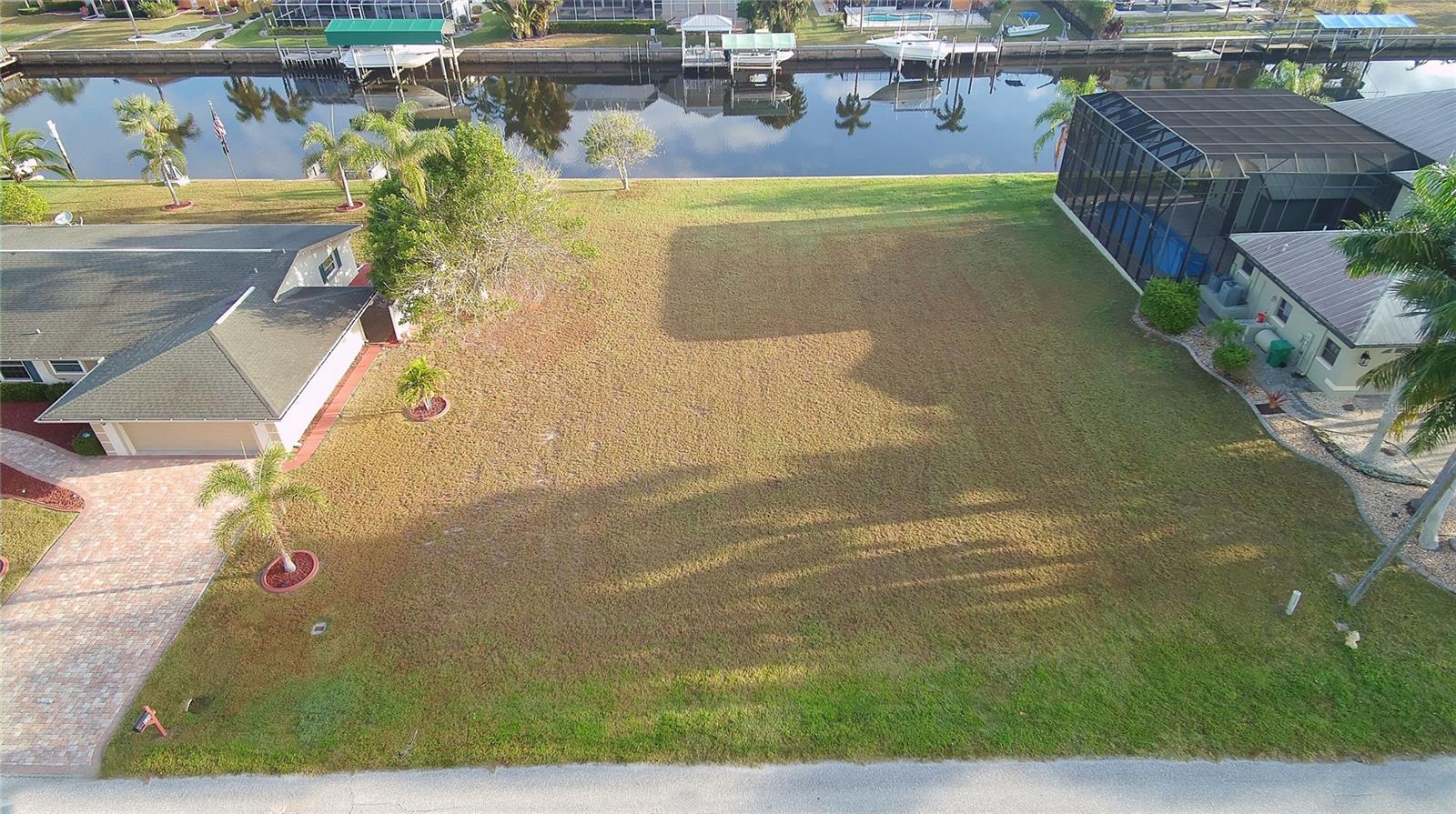 A Large Beautiful lot with a very short ride to Charlotte Harbor. No bridges, great sailboat water with some of the best fishing you could ever ask for. If interested, the seller is offering a complete Home Plan for this lot. Plans are valued at $ 20,000 See attached sketches.
A new REC Center with pool and a new pool house IS being built at the end of Harbor Blvd at the Waters Edge just two blocks away. Completion date is November 2026. This facility will be set for community events as well as facilities for Sailing and Regatta Events. The Boat Launch Ramp is available now. Come and enjoy our Paradise. YOU DESERVE IT.