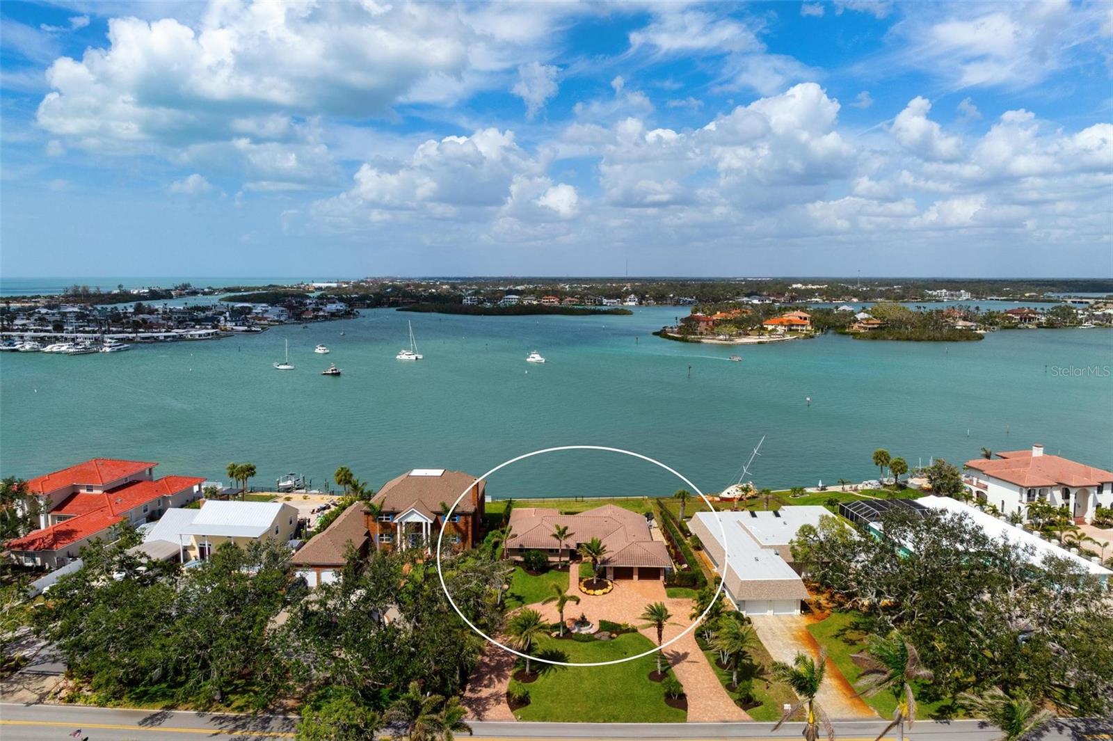 Breathtaking, expansive water views of Roberts Bay await you in this wonderful home in downtown Venice close to the beach and quaint shops. This home has been completely remodeled and professionally decorated by Clive Daniels and sold turnkey. There are too many features to list individually. To mention a few: hurricane impact sliding glass doors and windows, new AC 2024, beautiful travertine tile that runs throughout, tile roof 2011, new whole house generator with separate automatic transfer during power outage plus a new seawall. As you drive up the circular driveway you see the lush landscaping that is fed by a 330 ft private well. Enter your home and to the right is the main living space which includes the living room, dining room, dinette area and kitchen all with stunning Bay views. Let’s highlight the kitchen with its Marine grade NEFF cabinets with stamped stainless and glass drawers. There is a quartz countertop with a waterfall drop on the island and a breakfast bar. Enjoy preparing meals on the gas stove with a stainless-steel hood. Need to escape the main living area? Relax in the separate family room with built-in shelving as well as another view of the water. Retire to the primary bedroom and relax in the sitting area with a wall of impact glass windows and watch the boats go by or the sun setting. Plus 2 walk in closets. The primary bath is stunning and en-suite. Now let’s move outside! The serene water views are in every direction. Float in your infinity pool, relax in the hot tub or entertain on the expansive paver deck, whether in the covered or uncovered areas. There is even a fenced green space for your fury friends to play! No hurricane damage to this home. From this amazing waterfront home, you can easily access all the restaurants, quaint shops, the art center, the beach and all the Island has to offer.