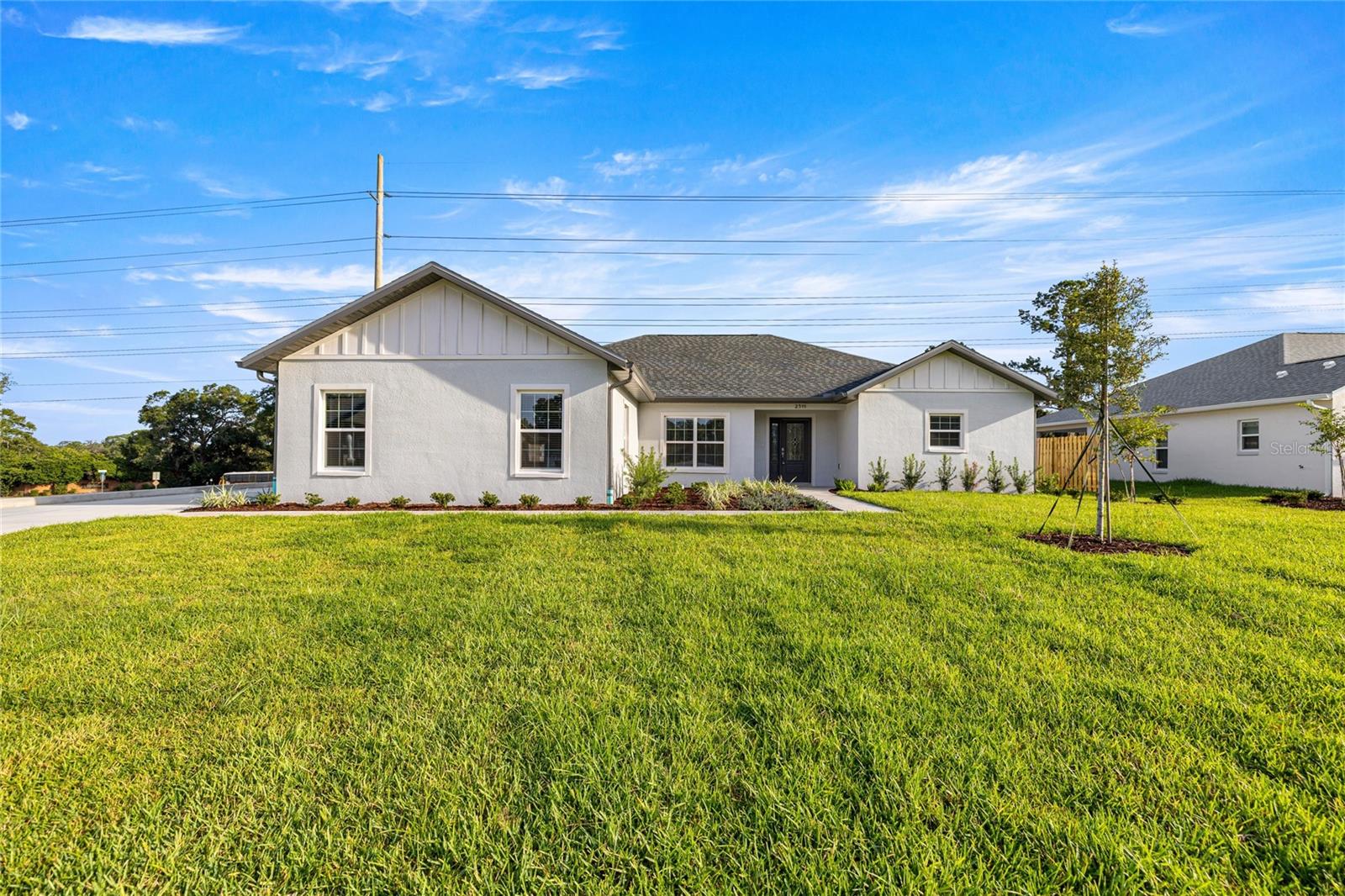 Welcome to your dream home! This stunning 3 bedroom, 2 bathroom house with a FLEX ROOM has been beautifully constructed and is located in the desirable SE community of Hunter’s Ridge. As soon as you enter, you'll be greeted by a bright and spacious open floor plan. The living room is perfect for entertaining guests and features large windows that provide plenty of natural light. The kitchen is a chef's dream, with high-end stainless steel appliances, sleek cabinetry, and gorgeous countertops with an amazing breakfast bar. Appliances include a built in oven, built in microwave, drop in range, double door refrigerator and deep drop-in sink. You'll love preparing meals in this space, whether you're cooking for yourself or a crowd. The master bedroom is a tranquil retreat with a french door that leads to the covered lanai, complete with a walk-in closet and an en-suite bathroom that features dual sinks, a soaking tub and a walk in shower. The two additional bedrooms are well sized for children, guests, or a home office. The Flex Room could be used as an office, homeschool room, library, craft room, 4th bedroom or whatever it is that you need additional space for! The Laundry Room is oversized and has tons of cabinet storage and countertop space. It also includes a washer and dryer. Outside, you will find a WHOLE HOUSE GENERATOR for peace of mind during storm season, epoxy on the floor of the Garage, gutters around the perimeter of the home, upgraded landscaping, irrigation system, a masonry wall to the back for privacy and a fence alongside the porch for privacy. This home is perfect for anyone looking for a luxurious and comfortable lifestyle in a well planned, in town community. Don't miss your chance to make this stunning new construction house, built by a custom home builder, your own! Hunter’s Ridge is located within 10 minutes of downtown Ocala. Numerous cultural venues, art galleries, restaurants, medical facilities, and retail stores are within a 10 minute drive. Hunter’s Ridge also offers easy access to all major roadways to include I-75, US 441 and US 301. When you see it you will love it!