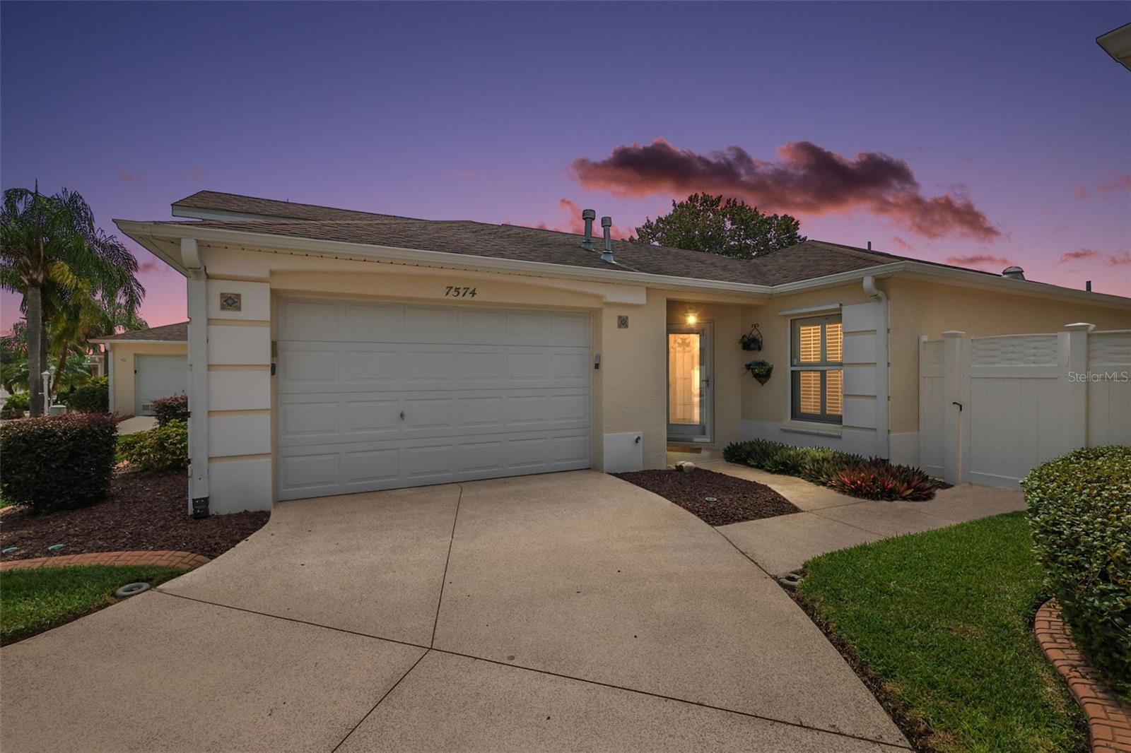WONDERFUL TURNKEY BLOCK and STUCCO 2/2 Beauregard Courtyard Villa with ENCLOSED LANAI, SIDE BIRDCAGE, and REAR STONED PATIO all within a PRIVATE, FULLY FENCED yard in the charming Greenwood Villas of the Village of Calumet Grove! LOW BOND- only $1,347! Stoned planting beds with curbed edges, decoratively painted walkway, and a beautiful STAINED GLASS door welcome you in to this INCREDIBLE villa! The AMAZING kitchen boasts PLANTATION SHUTTERS, ALABASTER WOOD cabinetry with PULLOUTS, GAS cooking, SOLAR TUBE, PANTRY closet, PASS-THRU WINDOW to the dining room, and an ADJACENT DINETTE area. The OPEN CONCEPT floor plan of the living and dining rooms creates a SPACIOUS main living area - perfect for entertaining friends and family! From the living room, step through sliding glass doors, into the FABULOUS OUTDOOR LIVING area of the PRIVATE ENCLOSED LANAI with FULL-LENGTH SLIDING PANELS and an exterior French Door. For outdoor enjoyment, an extended SIDE BIRDCAGE is located just off of the dining room featuring PAVER floors and a remote-controlled retractable AWNING. There’s also a REAR STONED PATIO surrounded by MATURE landscaping creating a TRANQUIL space to RELAX, UNWIND, and ENJOY the gorgeous Florida weather! Back inside, retreat to the primary bedroom boasting a SPACIOUS WALK-IN closet and SLIDING GLASS DOORS to the ENCLOSED lanai. It’s en-suite bathroom features TILE floors, WHITE cabinetry, TILED WALK-IN shower with glass doors, make-up vanity, SOLAR TUBE, and LINEN closet. The second bedroom and en-suite bathroom are located just off of the foyer. Bedroom two offers a large window, plantation shutters and a built-in closet. The second bathroom features a WHITE vanity and a tub and shower combination. The one and half car garage boasts a GENEROUS laundry area with WHITE cabinets and shelving, a ceiling fan, utility sink, attic access with pull-down stairs, an ABUNDANCE of shelving, and PLENTY of space for a car and a golf car! Additional features include a CUSTOM SCREEN GARAGE DOOR WITH OPENER, Added INSULATION and FOAM-INSULATED ducting for energy efficiency, and A FULLY FLOORED ATTIC STORAGE AREA. DON’T MISS YOUR OPPORTUNITY TO OWN THIS GORGEOUS HOME! The Village of Calumet Grove is conveniently located close to Nancy Lopez Championship Golf and Country Club; numerous executive golf courses; the fantastic new First Responders Recreation Center; Mulberry Grove Pool and Recreation Center; Calumet Grove Neighborhood Pool; the Savannah Center; the VA Hospital; and an abundance of shopping, restaurants, banking, and more! PLEASE WATCH OUR WALKTHROUGH VIDEO of this FANTASTIC COURTYARD VILLA and call today to schedule your Private Showing or Virtual Tour!