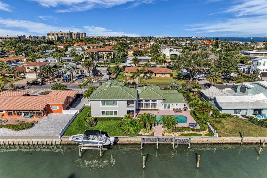 Price Reduction of $75,000.00. Step into modern luxury at this canal-front masterpiece on the south end of Longboat Key. Nestled in the premier Country Club Shores neighborhood, this 2024-effective-year renovation seamlessly blends classic Florida charm with cutting-edge innovation. Built with top-tier materials and state-of-the-art systems, this home offers coastal waterfront living in an unrivaled location. The southeastern exposure provides an abundance of natural light and water views. Everything has been addressed with this custom renovation, and the fully restored interior showcases thoughtful upgrades throughout, including Lutron programmable lighting, a German-designed kitchen lighting system, new plumbing and electrical, impact windows and doors, a must-see chef’s kitchen, instant hot water delivery and a whole-home water filtration system. Coral stone floors on the main level and hardwood flooring above complement the refined design, curated by the owner, a professional interior designer. This residence offers three bedrooms and three-and-a-half baths, including a full-floor principal suite featuring a sitting room, private balcony with Sarasota Bay views, and generous closet space. A sizeable living room designed for entertaining separates the en-suite guest wing from the main living areas. The kitchen includes custom cabinetry, high-end appliances and a breakfast room overlooking a private front courtyard. Additional main-floor spaces include a library or game room, powder room, laundry room, exercise room and a framed, wired area for a future elevator. Outdoors, lush tropical gardens envelop the entire property, creating a tranquil and Zen-inspired sanctuary leading to a covered lanai overlooking a resort-style pool and spa, with expansive patios ideal for entertaining. The canal-side setting includes a private dock with a boat lift and mooring capabilities for a larger vessel with no bridges to the bay and access to the Gulf in minutes. Enjoy sunrises over Sarasota Bay and amazing sunsets and water activities from your designated beach access just a short stroll away. The Country Club Shores neighborhood is known for coastal living, with low HOA fees and the location provides easy access to golfing, shopping, dining at St. Armands Circle and downtown Sarasota.