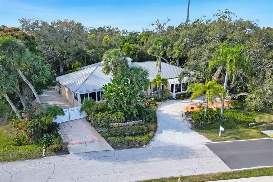 A rare waterfront estate overlooking tranquil Old Tampa Bay. This extraordinary Safety Harbor property features generous spaces that owners can easily adapt to their lifestyle. Set on approximately two thirds of an acre, there is plenty of room for a pool, if desired. This residence is surrounded by a natural canopy of trees that create a serene, private retreat with spectacular bay views. The property rewards imagination-one where the future use is defined by its next owner. This high end property provides its new owners with many options that are not typically found in traditional settings. There is a buildable lot, and if desired could serve as a multigenerational family compound, or a legacy property for future resale. 3 spacious bedrooms, all with views of Old Tampa Bay, 4 full baths, two dedicated office spaces-ideal for remote work or a creative studio. One living space is suited for a formal gathering while a second currently functions as a media room. Off the tastefully renovated (2017) open kitchen is a sun room which overlooks Old Tampa Bay, perfect for morning coffee as you watch the sun rise or enjoy the serene water view. The quiet spacious primary suite is a retreat, featuring 2 separate and large walk-in closets with built-ins. Beyond this sleeping area is a charming flex room with Old Tampa Bay views suitable as a buyer sees fit. A large screened side porch on the northside enhances an indoor-outdoor lifestyle. On the south side a large concrete pad suitable for RV or boat parking with sewer clean out, and electric ready for plug ins, a unique feature in this setting. A three-car garage, provides additional convenience. A new Generac whole house generator, offers peace of mind and uninterrupted electrical service. This property has never had any storm damage. The lush landscaping creates a true Old Florida sanctuary, defined by mature vegetation and intentional native plantings providing seclusion. Established trees and dense natural foliage create a park-like environment and Philippe Park is steps away! There are pavers, shelled pathways and garden art winding throughout the grounds inviting quiet walks. The property is partially fenced and gated offering a secure setting. A free-standing garden shed, with electric and water, provides a practical space for garden and work tools. Additionally the property is equipped with a 2 private wells dedicated to irrigation, allowing the landscaping to be maintained efficiently and cost-effectively year-round. Just a short walk, bike ride or a quick trip via your golf cart brings you to the charming city of Safety Harbor, known for its welcoming, small town atmosphere. SH blends historic character with a lively downtown filled with locally owned shops, cafes and restaurants. Local events, art festivals and farmers markets create a strong sense of community. From this home you are able to reach two International Airports in approx. 20 minutes. This location is very close to both Tampa and St. Peterburg downtowns, offering culture, museums, major sporting events, and some of the finest restaurants, plus. Head west to the sugar sands of Clearwater Beach and stunning sunsets. The totality of this property is truly ONE OF A KIND! Come discover everything this beautiful property has to offer!