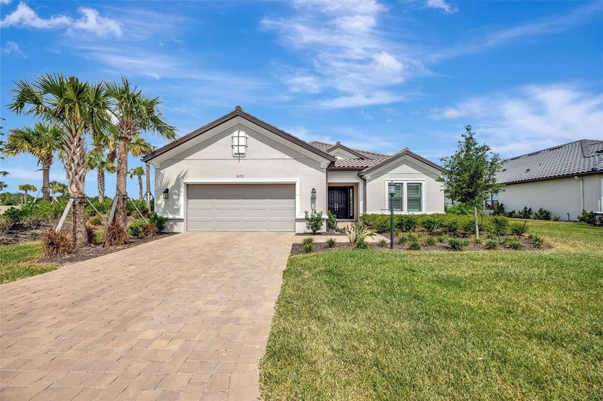 Built in June 2024, this is a rare opportunity, as there are no more non-golf lots available to build a Pallazio model in Esplanade at Azario. ANNUAL GOLF PASSES ARE AVAILABLE (CONTACT THE PRO SHOP FOR MORE INFORMATION AND FEE) The pool is the only virtually staged photo. This beautifully upgraded Pallazio model is situated on a premium corner lot with a water view in the front, a tranquil lanai view, and an easement between you and your only neighbor. 3,084 square feet. Offering 3 large bedrooms, 3 full bathrooms, an office, and a tandem 3-car garage, this home was thoughtfully designed for both luxury and comfort. Light gray wood plank tile runs throughout the living spaces, complemented by 8-foot doors and plantation shutters. The open concept living area features a tray ceiling, two sets of sliders, and a striking feature wall in the great room with lighted shelves, a sculptured three-sided fireplace, and a floating porcelain hearth. The extended gourmet kitchen boasts upgraded white shaker cabinetry with soft close doors/drawers, slide outs, a light gray oversized island, striking premium quartz countertops, custom organized pantry shelving, and GE Gourmet kitchen appliances. A private office/den with custom built-ins and double pocket doors offers a functional and quiet workspace. The oversized primary suite includes a cozy bay window sitting area, a custom walk-in closet with built-in shelving and drawers, gliding shoe rack and a luxurious spa-like bathroom with a large walk-in shower. Two additional spacious bedrooms each have their own full bathrooms for guests' comfort. Step outside to the extended lanai, designed for entertaining, featuring an extended outdoor kitchen with a Delta Heat gas grill, separate griddle, refrigerator, sink, and built-in storage. There is plenty of space to design your dream pool and spa, with pre-wiring already in place. Pool photos have been virtually staged. Additional highlights include a three-car tandem garage with epoxy flooring, motorized overhead storage, and a tankless water heater. Located in the highly desirable Esplanade at Azario, residents enjoy access to resort-style amenities including 2 pools, Bahama Bar, Culinary Center, golf course, fitness center, spa, dog park, pickle ball, tennis, bocce ball, community garden and more. This is a non-golf deeded house, so you don’t have the added expense of owning a golf lot but all the opportunity to golf! (Golf fees currently $50 per round, HOA fees are $280.00 less per month than owning a golf deeded house.  This home is move-in ready waiting for you to enjoy the luxurious Florida lifestyle! Seller is flexible on closing date.  Pool photos are the only photos virtually staged.