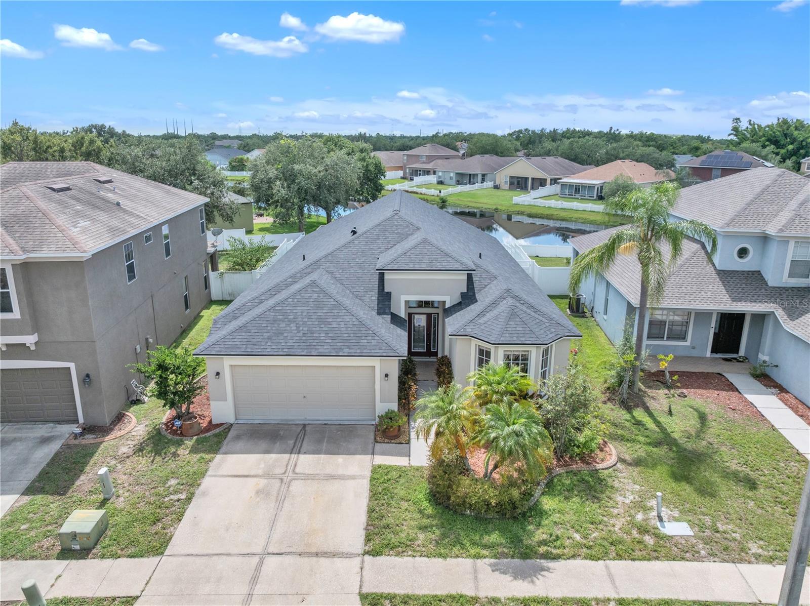 WELCOME TO THE SUNSET HOUSE - Private SUBURBAN community of Amberly in Parkway Center! This beautifully maintained OPEN FLOORPLAN 3-bedroom, 2-bathroom pool home with a 2-car garage offers 1,741 sq ft of living space and is perfectly positioned on a tranquil pond for breathtaking sunsets from the pool Lanai. Built in 2001 with full CONCRETE BLOCK construction, the residence features SOARING 12 FOOT CEILINGS, a desirable split floor plan, and an inviting living area with BRAZILIAN HARDWOOD FLOORING and insulated glass doors that open to the screened, Sparkling HUGE SCREENED POOL LANAI AND DEEP POOL WITH SCREENED ENCLOSURE. The master suite includes a WALK-IN CLOSET, dual sinks, a garden tub, a glass-enclosed shower, and SLIDING GLASS DOORS OVERLOOKING THE POOL AND WATER. Outdoors, the birdcage-enclosed pool area is complemented by a spacious covered seating area and a FULLY FENCED BACK YARD with white PVC fencing and lush landscaping. A custom screened pool security fence is included! Recent upgrades include a 2025 BRAND-NEW ROOF with premium black charcoal shingles and black drip edge installed by Storm Safe Roofing & Exteriors, a 2022 YORK HVAC system, a 2018 Rheem water heater, and a 50-AMP home generator plug-in. The three-speed self-cleaning pool pump with jets keeps the pool sparkling, while the home’s low HOA of $320/year and low CDD of $1,226/year add to its appeal. COMMUNITY AMENITIES ARE ONE STREET TO THE SOUTH and include a refreshing community pool, a welcoming clubhouse, tennis courts, a playground, and a scenic park — all within a neighborhood where the roads have been freshly paved. This property offers the perfect blend of comfort, style, and Florida living in a peaceful, well-kept setting.*Free 1% rate buy down through use of preferred lender* **3D Video Walkthrough and Matterport Floor Plan Available!**