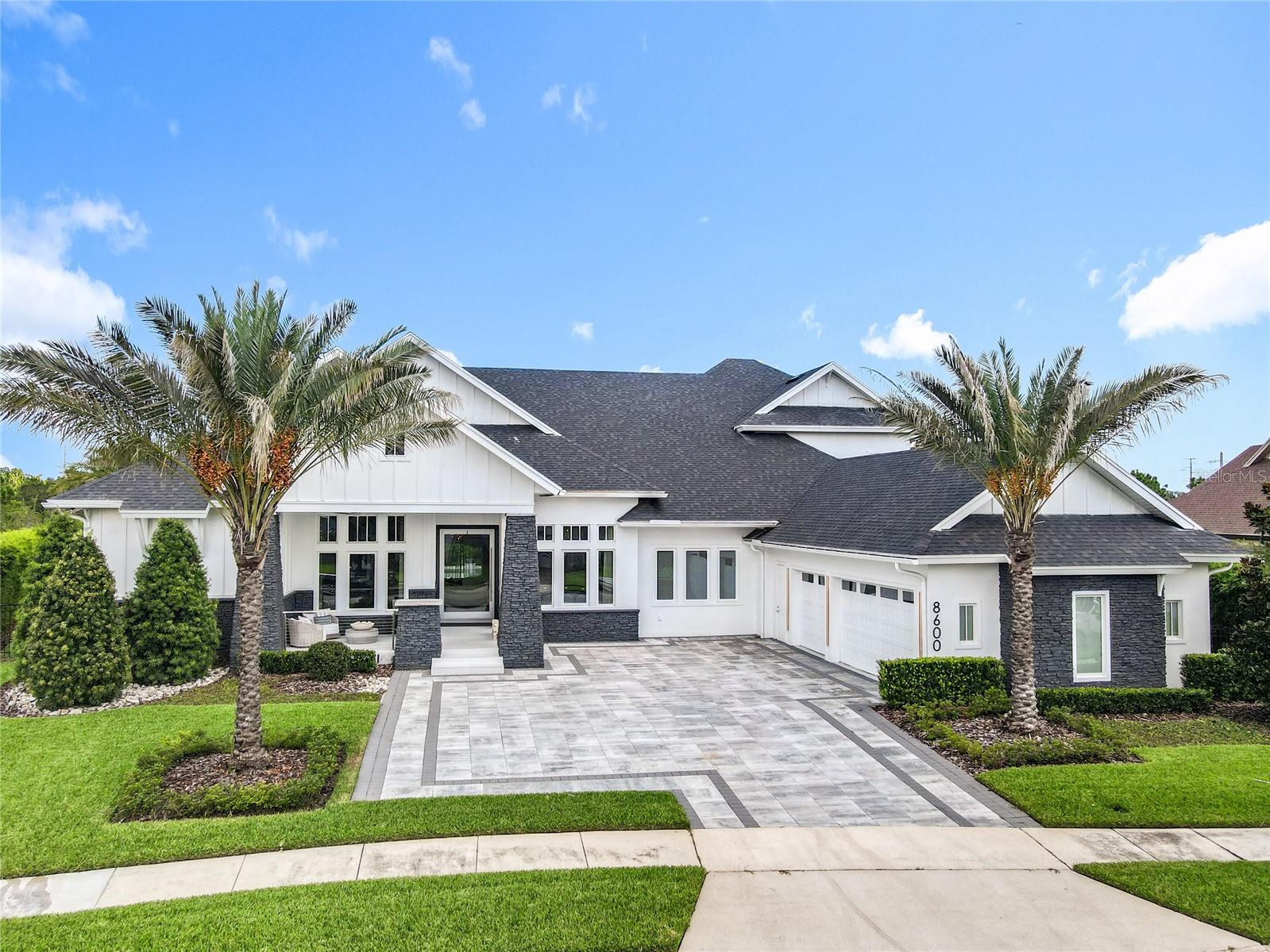 Experience Luxury Living at Its Finest. This warm, contemporary residence blends modern-transitional style with the highest level of finishes throughout. Offering approximately 5,718 sq. ft. of living space and nearly 7,594 sq. ft. under roof, every detail of this home is crafted to deliver elegance, functionality, and lifestyle excellence. Featuring five spacious ensuite bedrooms plus an additional full bathroom, the layout is both versatile and inviting. On the main level, you'll find four bedrooms, including the luxurious primary suite a serene retreat with two oversized walk-in closets and a spa style bathroom adorned with exquisite finishes. Additional main-level spaces include formal living and dining rooms, an open-concept kitchen-family room-eating area, a Florida room, a spacious laundry room, a dedicated home office, and a three-car garage with ample storage. Upstairs offers one more bedroom and a versatile multi-purpose room, all set on a .71-acre lot. At the heart of the home, the gourmet kitchen showcases frameless contemporary cabinetry with automatic lighting, a generous center prep island, three built-in pantry cabinets and premium Wolf and Sub-Zero appliances. The kitchen flows seamlessly into the spacious great room and Florida room, creating the perfect indoor-outdoor living experience. Step outside to your private outdoor oasis, where beautifully landscaped grounds frame serene conservation views. Enjoy a sparkling pool, relaxing spa, summer kitchen with Bull premium appliances, tranquil yard, expansive covered living space, a fireplace and a basketball court. With plenty of outdoor seating areas, this space is designed for year-round entertaining. This exceptional home combines sophisticated design, luxurious finishes and an unbeatable layout perfect for both everyday living and memorable gatherings.