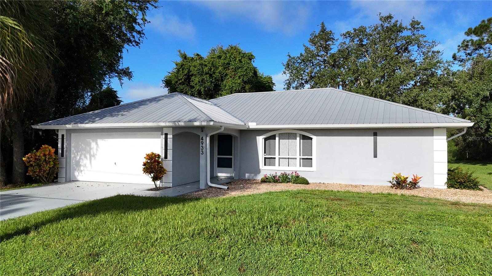 **PLEASE TAKE A WALK THROUGH YOUR NEW HOME WITH THE 3D INTERACTIVE VIRTUAL TOUR*** Welcome to this meticulously maintained and tastefully updated 3-bedroom, 2-bathroom home located in one of North Port’s most sought-after neighborhoods! Boasting CITY WATER, 2022 METAL ROOF & 2021 A/C (Both w/10yr warranties), NEW soffit & gutters in 2023 with built-in electrical outlets, this property offers peace of mind and move-in-ready convenience. Pull up the driveway to be met with fresh landscaping, pebble rock, exterior lights, flagpole and a charming arched entryway as you walk into the new place you'll call "home." Step inside and instantly feel at home as you're greeted by a bright and open floor plan, featuring high, vaulted ceilings, neutral tones, upgraded lighting and BRAND-NEW luxury vinyl plank flooring throughout - complete with a LIFETIME WARRANTY! Large front windows align the living room, allowing the natural sunlight to shine through. The heart of the home is the FULLY REMODELED kitchen, featuring granite countertops, tile backsplash, soft-close cabinetry, farmhouse sink, built-in closet pantry and a centered island with additional storage and seating options - all beautifully lit with pendant and recessed lighting. What more could you ask for? How about all the stainless-steel appliances being included in the sale? Enjoy casual meals in the dining area with a lovely view of the backyard or step through the sliding doors to your private screened lanai - the perfect spot to relax, sip on your morning coffee or soak up the Florida sunshine. The desirable split-bedroom layout offers privacy for the spacious primary suite, complete with lanai access, walk-in-closet with shelving and a stunning en-suite bath with Roman-style walk-in-shower, granite vanity and private toilet closet. The guest bedrooms are good-sized with plant shelves, new ceiling fans, and ample closet space. The updated guest bath includes a tiled shower/tub combo, modern vanity, and upgraded fixtures. The attached 2-car garage features a painted floor, custom shelving, attic access, bike hooks, LED lighting and a laundry area with washer/dryer hook-ups. Whether you're looking for your forever home or a seasonal retreat, this North Port gem offers a perfect blend of comfort, style, and functionality – all within close proximity to I-75, Schools, dining and the Cocoplum shopping center. Just a short distance to golf courses, Wellen Park, Atlanta Brave's Stadium and some of the most gorgeous beaches the U.S. has to offer! At this price - this home won't last long! What are you waiting for? Come out and make your offer today - You won't be disappointed!