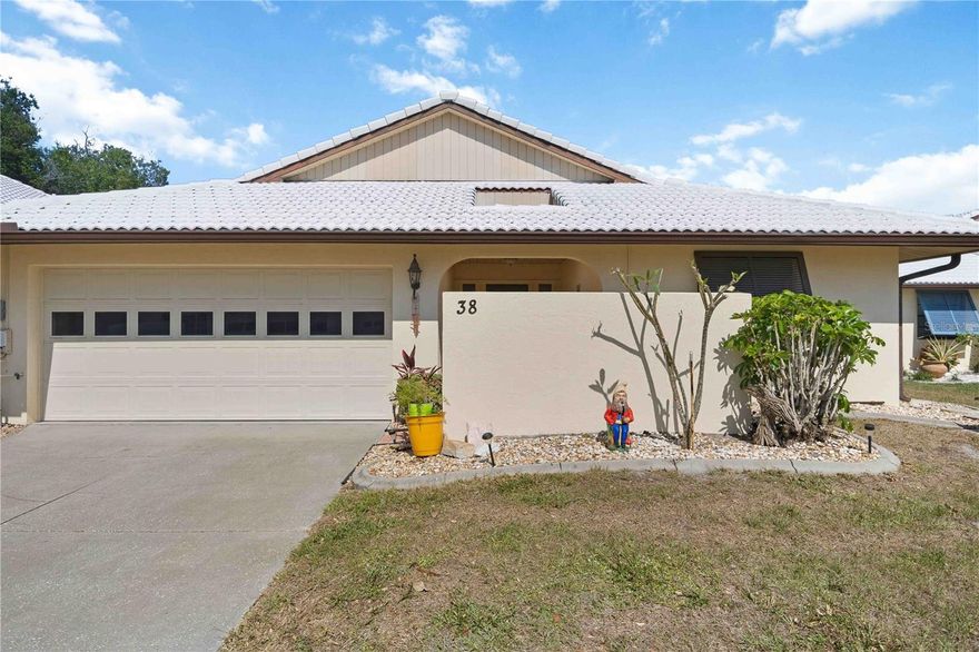 Discover Hourglass Lake Villas — an intimate community of just 80 villas, welcoming of all ages, and one of South Venice's most quietly coveted addresses. Just minutes from Venice Island, Manasota Key, Gulf beaches, dining, and shopping, the location is as effortless as the lifestyle. Tucked in near the front of the neighborhood, this waterfront two-bedroom, two-bath villa offers a thoughtful split-bedroom layout with a hidden pocket door that creates a fully private guest suite with its own bath. A bright lanai with sliding glass doors connects the living area and primary suite, while a private courtyard off the kitchen and primary bathroom invites you to start mornings at your own pace or enjoy a beautiful cross breeze through the home. Thoughtful details throughout — adjustable exterior Bahama shutters for filtered light and privacy, generous storage including a walk-in primary closet and attic access, and a well-appointed eat-in kitchen with a newer stainless steel refrigerator and dishwasher, recessed lighting, and abundant cabinetry. The laundry room includes a utility sink and additional storage space, which leads out to the oversized two-car garage. The low HOA includes a heated and cooled pool, spa, private clubhouse, professional landscaping, and an active social calendar — a true lock-and-leave lifestyle with the warmth of a close-knit community. Schedule your private showing and experience this Venice retreat for yourself.