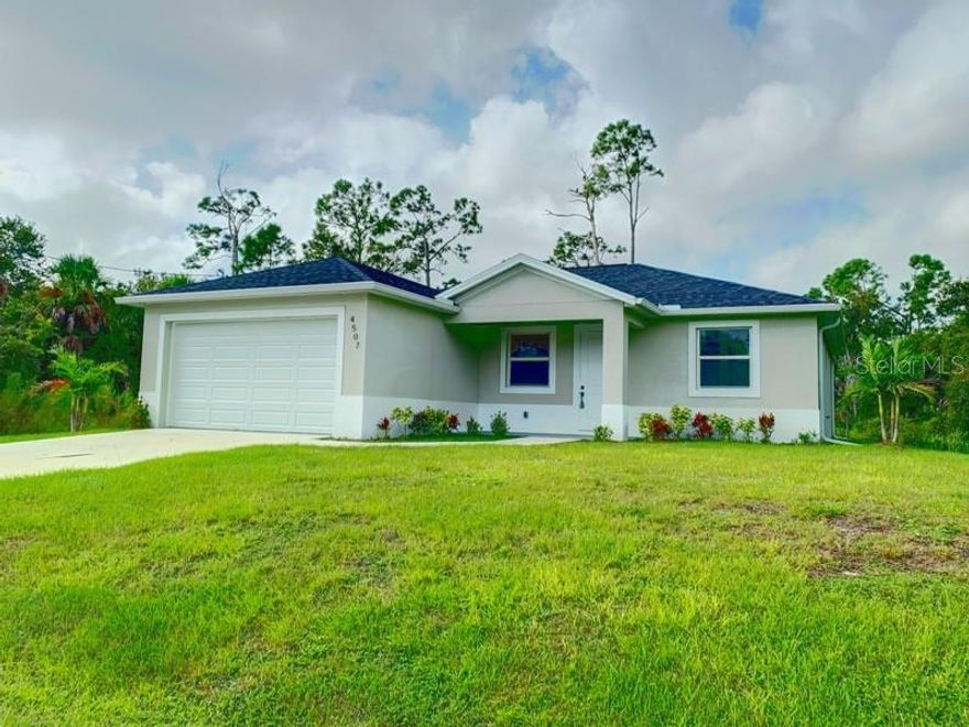 Experience the feel of a brand-new home in this spacious 3-bedroom, 2-bath residence. Enjoy the covered open-air lanai overlooking serene trees, perfect for relaxing in a peaceful natural setting. The home features hard surface flooring throughout.  The modern kitchen offers a large center island, stainless steel appliances, hard surface countertops, abundant of sleek design cabinet space, pantry, open shelving and a built-in microwave—ideal for cooking and entertaining. Living room Dining room combo with recessed lighting, already installed TV mount and open space enhances the home’s open and airy feel, while hurricane-rated windows provide added safety and energy efficiency.   Additional highlights include a water softener system for the well water supply and tranquil surroundings that create a true nature lover’s retreat.  Home available for immediate possession with approved application.