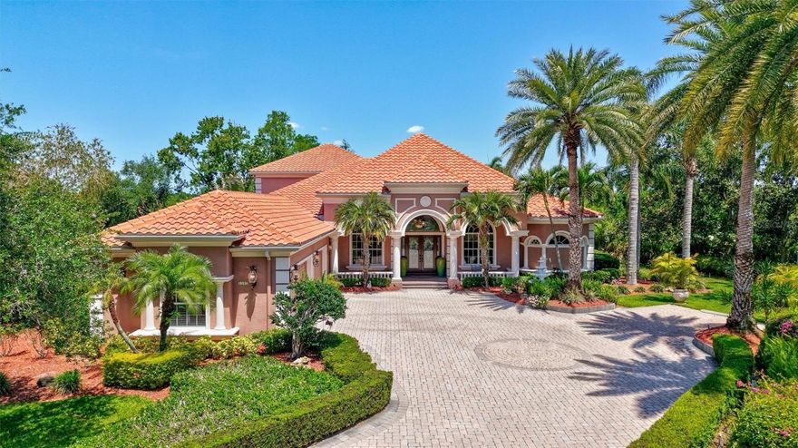 Set on a quiet cul-de-sac, this custom estate blends timeless design, modern systems & serene natural surroundings. Thoughtfully positioned to capture sweeping views of the protected 15-acre preserve, the home reflects refined Florida living where light, landscape and architecture work in harmony.  A stately façade, 2023 concrete tile roof & lush landscaping introduce a residence built with enduring quality. Inside, exemplary craftmanship is evident throughout with attention to details that create a warm, inviting backdrop for everyday living & elegant entertaining. With 5,653 sq. ft. of interior space, the floor plan flows seamlessly, connecting indoor and outdoor environments. The main floor centers around a chef’s kitchen designed for gourmet preparation & effortless hosting. High-end, double appliances support large gatherings with ease. A generous prep island & custom millwork elevate both function and artistry.  The adjacent morning room features aquarium-glass windows faming panoramic views, complimented by an entertainment wet bar. Also on the main level is a tranquil primary wing with a spa-like ensuite, a private guest ensuite and 2 dedicated offices ideal for work, creativity or quiet retreat. The expansive lanai offers 559 sq. ft. of covered outdoor living designed for year-round enjoyment. An outdoor kitchen, fireplace, custom pool/spa & generous seating areas extend the home’s interior comfort outdoors. A suite of premium mechanical upgrades enhances peace of mind, including a Rinnai instant hot water heater, Honeywell smart thermostats, integrated security systems, a PVE 2-person elevator, PGT ThermaTru impact-resistant windows, Lennox HVAC systems, whole-house in-wall vacuum, & a Guardian Elite 20kW standby generator. The 4-car garage features upgraded insulation for doors & ceiling & a Daikin split A/C – ideal for collectors, hobbyists, or climate-controlled storage. Located in the X-flood Zone & professionally pre-inspected with repairs completed, this home offers confidence & ease. More than a residence, it is a private retreat where architectural quality meets natural beauty & luxury is expressed through comfort, design & enduring value. The Silver Oak community is located on 115 acres of natural preserves & lakes. Conveniently located in Palmer Ranch, there is easy access to famous Sarasota Beaches, Legacy Trail, outstanding Golf Courses, Downtown Sarasota & Venice.
