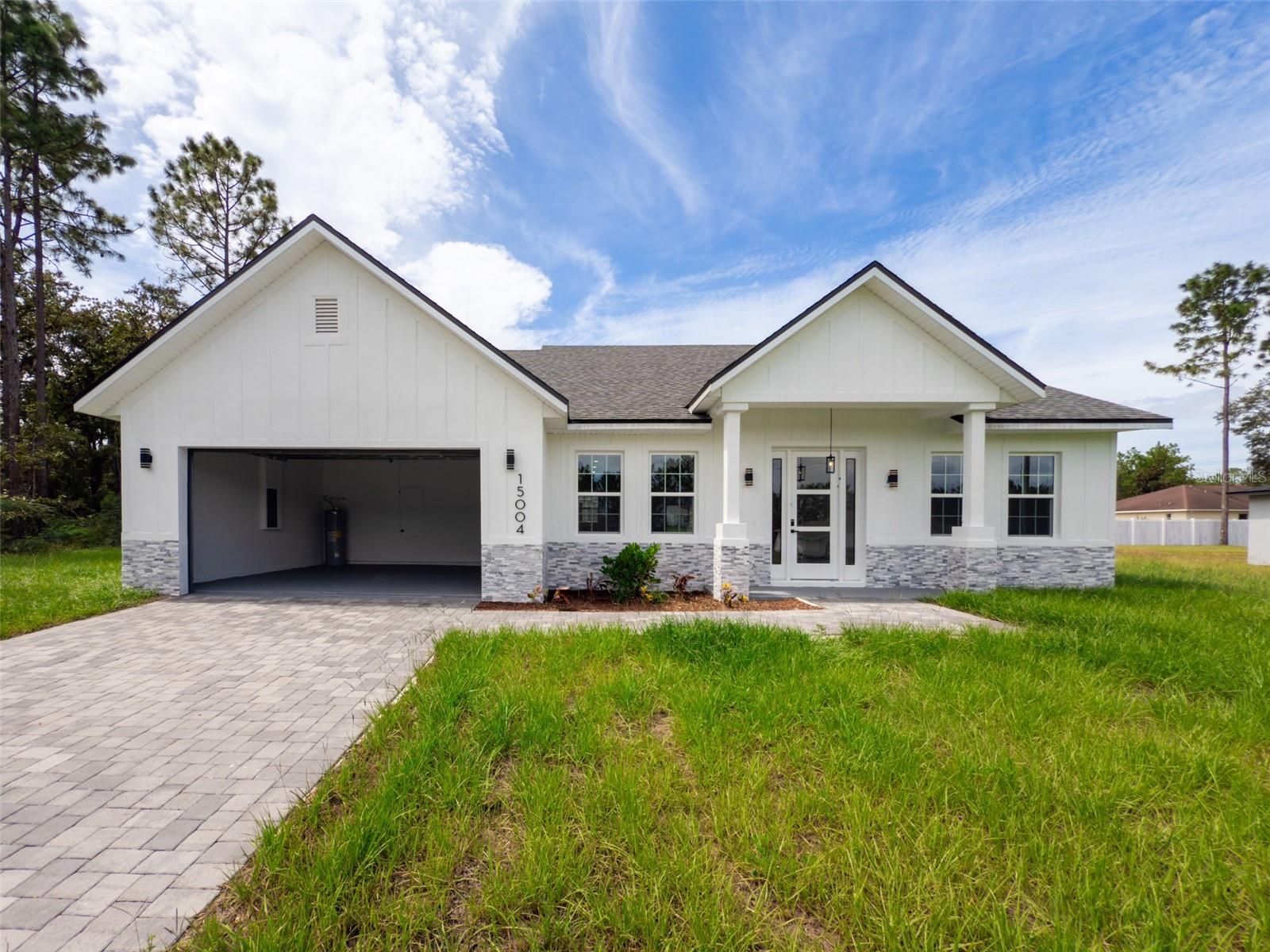 ** OVERSIZED LOT**This stunning home, located on a spacious lot has 4 bedrooms and 2 full bathrooms and 1 half-bathroom, large living room with open concept kitchen, equipped with stainless steel appliances including a range, refrigerator, garbage disposal, dishwasher, and microwave, as well as an island and ample cabinet space, perfect for hosting large family gatherings. Rooms are spacious and comfortable, which allows for seamless flow and natural light throughout the home. The house has several upgrades, such as vinyl flooring, floor to ceilings tiles on bathrooms and huge lanai with countertop and sink, plenty of space for outdoor kitchen. With a two-car garage, in addition to being more spacious, has a greater height than standard. It is a perfect place to live or invest.