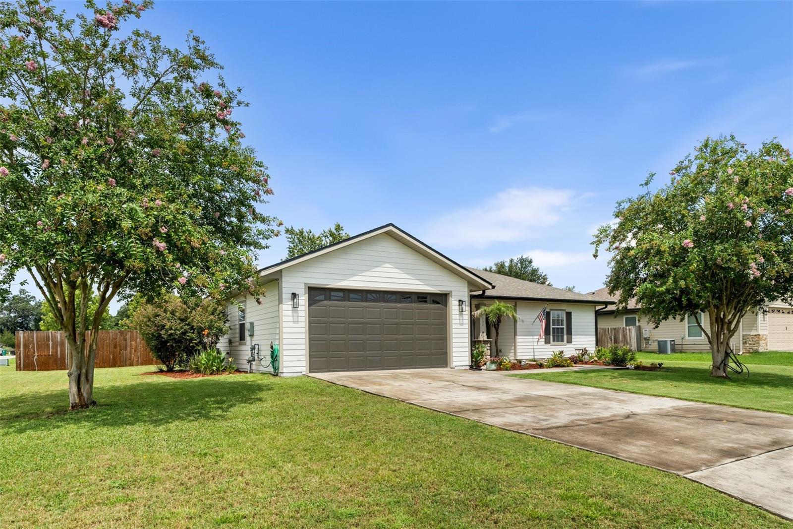 One or more photo(s) has been virtually staged. Welcome to this beautifully updated home tucked away on a spacious corner lot in the peaceful back section of Newberry Oaks! With upgrades completed just two years ago, this property is move-in ready and full of charm. From the moment you arrive, you'll notice the fresh exterior paint, lush landscaping, and inviting front porch—perfect for enjoying a quiet evening in a rocking chair. Step inside to find thoughtful touches throughout, including board and batten accents in the entryway and dining room, updated light fixtures, fresh interior paint, and durable luxury vinyl plank flooring. The kitchen shines with a NEW refrigerator and appliances that are only two years old, crisp white cabinetry, and a cozy breakfast nook featuring a woven light fixture that adds warmth and style. The split floor plan ensures privacy, with the spacious primary suite offering a shiplap feature wall, tray ceiling with lighting, a large walk-in closet, and a well-appointed en-suite bath with a jacuzzi tub. Across the home, you’ll find three generously sized guest bedrooms and a full bath. Additional features include a new roof installed in April 2025, new rain gutters added in 2024, an extended back porch, a fenced-in backyard with gorgeous landscaping, a programmable thermostat, and a Wi-Fi capable garage door opener—perfect for modern convenience. Don’t miss this gem—schedule your private showing today!