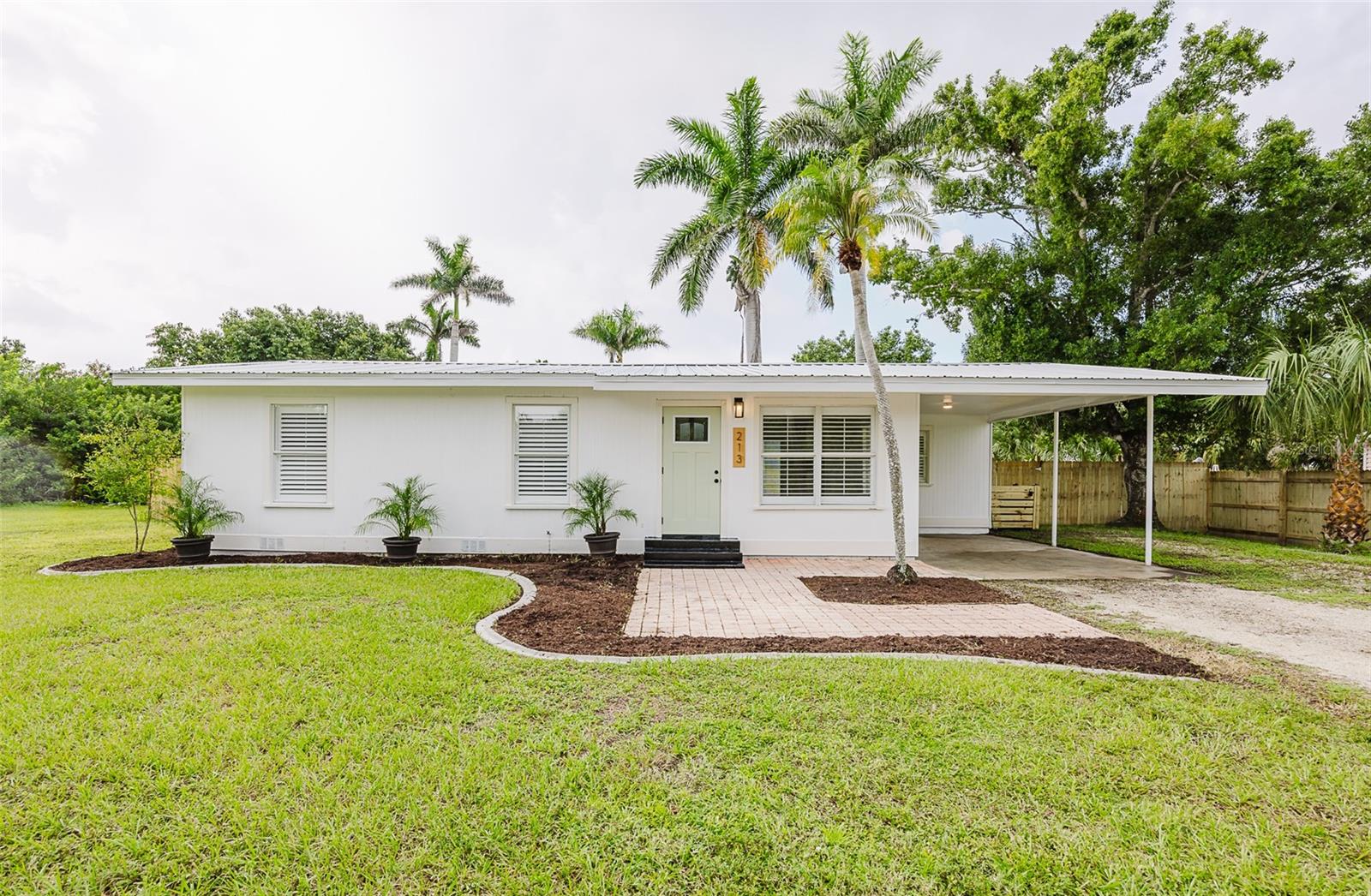 Rare find in Historical Punta Gorda! Homes in this neighborhood rarely come to market, and this one has been completely gutted and fully renovated! Listen to the church bells ring on the hour in this home featuring 3 bedrooms / 1.5 bath and sitting on an oversized 0.33 acre lot (two parcels combined), this property offers plenty of room to spread out and enjoy your private sanctuary. A brand-new fence surrounds the spacious backyard, and there’s even a concrete slab ready for a shed or workshop. The home also features a durable metal roof for long-lasting peace of mind. Step inside and you’ll immediately appreciate the attention to detail. The kitchen has been beautifully updated with stainless steel appliances, wood cabinets, and quartz countertops. A redesigned laundry room provides space for a stackable washer and dryer, folding station, and storage. Plantation shutters throughout add both style and energy efficiency, helping control sunlight while giving the home a cozy cottage feel. Every system has been updated for your comfort and peace of mind. The home includes new insulation, LED lighting, DC ceiling fans, a tankless water heater, and a brand-new HVAC system to keep energy costs low. All drain lines have been replaced with PVC, eliminating the concerns of cast iron pipes, and all water lines are now CPVC, so there are no old copper lines to worry about. Location is unbeatable—you can walk to a local ice cream shop, bike to downtown Punta Gorda, or take a quick 5-minute drive to Fisherman’s Village. Schools, shopping, dining, and entertainment are all close by, making this the ideal place to live, work, and play. With no restrictions on short-term rentals, this home is also an excellent investment opportunity. Don’t miss your chance to own this beautifully renovated, move-in ready property—schedule your showing today!