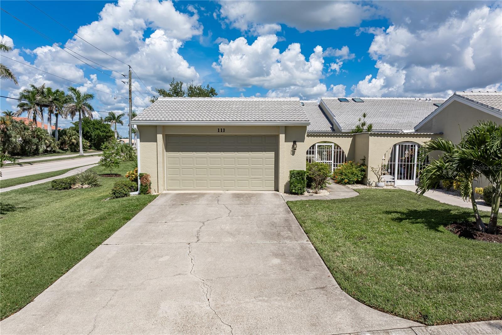 PGI WATERFRONT VILLA W/DEEDED DOCK, SAIL ACCESS & SCENIC LAKEFRONT VIEWS - Ideally located in heart of Punta Gorda Isles, this spacious 3 bed/2.5 bath villa w/just over 2,000 sqft in Isles Cove delivers picturesque lake views, a deeded dock just steps from your door, and direct sailboat access to Charlotte Harbor — all within a beautifully maintained, park-like setting. Inside, the home’s layout is spacious & bright w/cathedral ceilings & skylights that enhance it all. A wall of sliding glass doors opens to the lanai extending the living space outside. Sliding glass doors & windows frame tranquil lake views from the great room and lanai. The open-concept kitchen offers warm wood cabinetry, granite counters, under-cabinet lighting, updated appliances & a closet pantry. Pass-through counters to the dining area make entertaining a breeze. Architectural details include a formal entry w/coat closet, soaring cathedral ceilings, arched doorways, wet bar & gleaming wood floors in the great room. The split-bedroom floor plan offers a private owner’s retreat with two walk-in closets and lanai access. The owner's en-suite bath includes dual vanities, a glass-enclosed tile shower, and a jetted corner tub. Two additional bedrooms offer flexibility for guests, a home office, or hobby space, and share a well-appointed guest bath. One guest bedroom has a Murphy bed already in place. The powder room off the main hallway adds convenience for entertaining. Outside, the spacious, tiled lanai overlooks the lake & gazebo. Out here, you'll be able to enjoy the extending living space year-round plus have access to colorful sunrises w/your morning coffee. The villa also features a private two-car garage connected by a gated courtyard entrance. Keep your boat just yards away at your deeded dock (Dock #23). Dock features water & shared, metered electric hook-ups plus a 10,000 lb boat lift (installed 2019). The entire unit was re-plumbed w/overhead piping. Other updates include a smart thermostat, NEW impact-resistant windows along Marion Ave, NEW A/C (2022), NEW refrigerator (2025), NEW ROOF (2024) & NEW plexiglass sliding windows on lanai (2022). Community amenities include a heated pool, guest parking, and beautifully landscaped grounds. Miles of sidewalks in Punta Gorda Isles connect you to Ponce Park, historic downtown, Gilchrist Park & Fisherman's Village. Life in Punta Gorda is about more than boating—it’s about enjoying every moment. Tee off at local golf courses, rally with friends on the tennis or pickleball courts, or pedal along miles of scenic bike paths. On weekends, the city comes alive with music, art fairs, and vibrant festivals. Add in the weekly farmers markets brimming with local produce and the boutique-lined streets of Marion Avenue, and you’ll see why Punta Gorda is a community where every day feels like vacation. Claim your spot in paradise by making an appointment today.