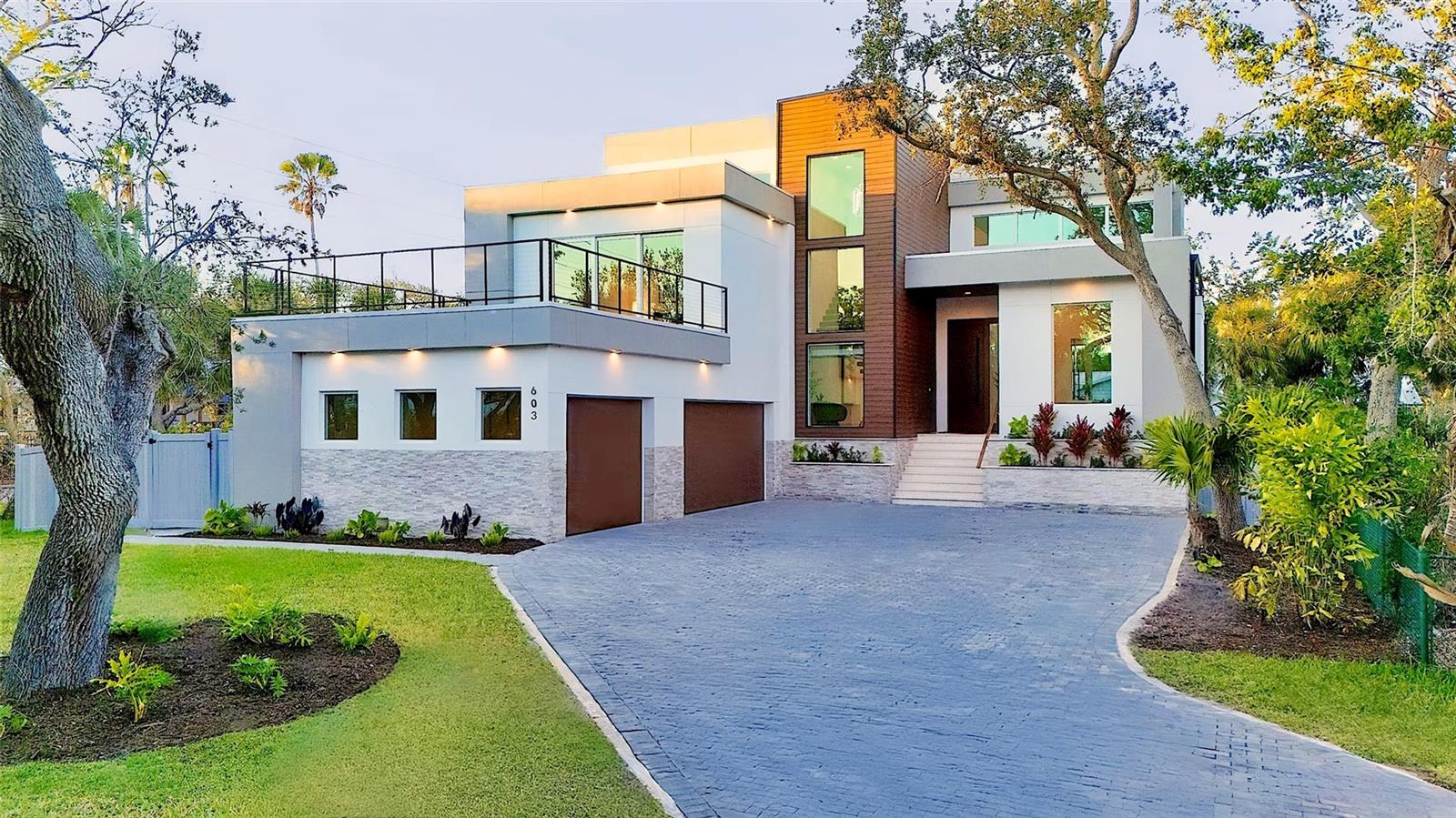 Perfectly positioned in the heart of Siesta Key, this masterfully crafted new construction estate by M&J Pham Development epitomizes modern luxury and architectural brilliance, offering 3,996 square feet of exquisitely designed living space with 4 bedrooms and 4.5 bathrooms. From the moment you step inside, you are greeted by a breathtaking open-concept layout accentuated by soaring 20-foot ceilings, floor-to-ceiling glass windows, and sleek porcelain tile flooring, all bathed in natural light and overlooking the lushly landscaped grounds. The state-of-the-art chef’s kitchen is a masterpiece of both style and function, featuring top-of-the-line Monogram appliances, porcelain countertops, and custom cabinetry, seamlessly flowing into the sophisticated living and dining areas. Designed for an effortless indoor-outdoor lifestyle, this home boasts multiple rooftop decks, two spacious patios, and a resort-style outdoor oasis complete with a fully equipped summer kitchen, built-in grill, pool, and spa. The primary suite is a private retreat, offering a tranquil terrace, expansive walk-in closet, and a spa-like ensuite with a soaking tub, glass-enclosed shower, and designer finishes. As you ascend the grand staircase to the upper level of the lavish estate, you are greeted with a breathtaking sight of three cozy bedrooms, each with its own private ensuite bathroom and featuring private access to a rooftop deck, creating the ultimate serene escape. Elevating the home’s sophistication, additional highlights include a temperature-controlled wine cellar, electric fireplace, custom walk-in closets, high-end quartz cabinetry, and a private elevator for seamless access to every level. Just moments from world-renowned Siesta Key Beach, fine dining, and premier shopping, this extraordinary residence offers an unparalleled combination of tranquility, elegance, and modern convenience. Your dream coastal retreat awaits—contact us today for a private tour!