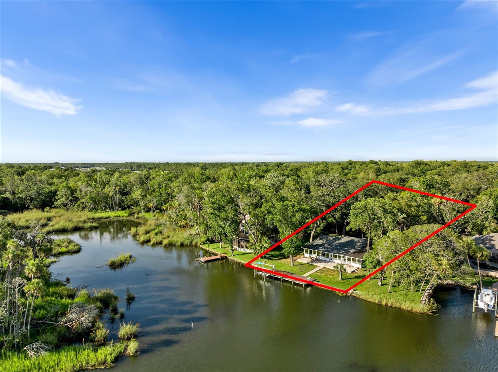 Looking for a spring fed waterfront property with incredible views, boat access, and unprecedented convenience? You found it! Welcome to one of the best homes in Crystal River! Located on a private drive with only 7 homes, and overlooking a several hundred acre preserve and estuary, it doesn’t get more private than this.
Spanning nearly 2,800 square feet, this home features 3 bedrooms, 2 updated bathrooms, a stunning custom kitchen with updated stainless appliances and granite counter tops, and more than 1500 square feet of open concept living spaces, in addition to a 2 car garage AND a 2 car carport.
However the real head turner in this home, is the 60 foot wall of windows offering unparalleled views of natural Florida wildlife from nearly every room.
Going fishing just got a whole lot easier with the 20’ boat lift ready for your pontoon or flats fishing boats.
But who needs a boat when you can catch redfish, mullet and snook right off your private TREX dock.
Watch hundreds of species of birds hunting the estuary while relaxing on your massive paver patio.
All of this just a 2 minute drive from Crystal rivers most popular restaurants, coffee shops, and even rural king!
It truly doesn’t get better than this!