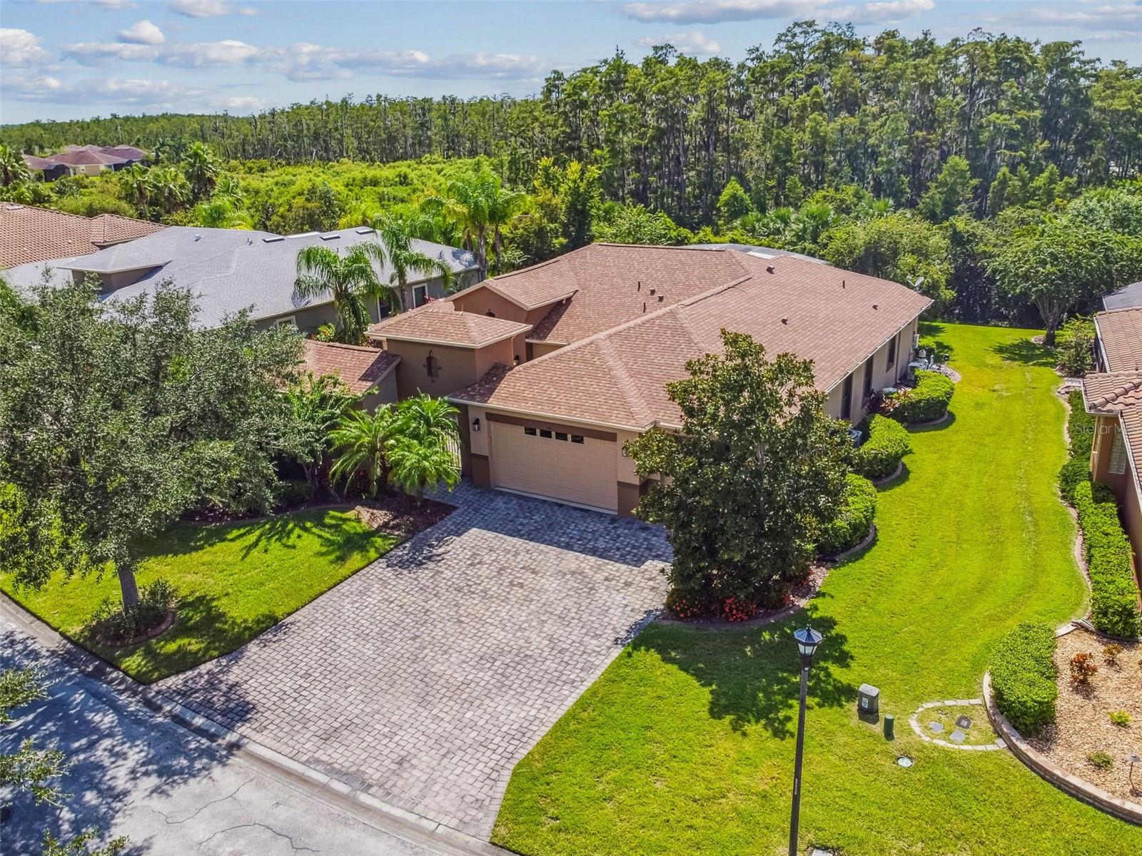 This exquisite Venetian Estate Pool model is located near the Palms Resort Amenities Center on an extra-large conservation lot, offering the perfect blend of privacy, space, and luxury. Featuring 4 bedrooms, 4.5 bathrooms, a guest cottage, dining room, den/study, a custom pool and spa, and a 3-car garage, this home is designed for both elegance and comfort. Enter through a gated courtyard with custom stone planters into the screened entryway and impressive double leaded-glass doors. The welcoming great room has overhead beams, a bookcase for 75" TV, and opens to sweeping views of the pool, lanai, and conservation backdrop. The chef’s kitchen is a true highlight with a large eat-at bar, Quartz counters, solid wood cabinetry, cook top, double ovens, and abundant counter and cabinet space. The adjoining breakfast nook overlooks the pool and conservation for a serene morning view. The primary suite enjoys private conservation views and a spa-like bath featuring dual vanities, split double walk-in closets, a soaking tub, and a walk-in shower. Bedroom #2 includes a Murphy bed and en-suite bath, while Bedroom #3 also features an en-suite bath. The separate guest cottage provides ultimate privacy with a full bath and walk-in shower. Additional interior highlights include a den/study with double-door entry and a formal dining room with a double tray ceiling. Step outside to the extra-large covered lanai and enjoy the custom pool and spa with extended screened enclosure, all framed by lush landscaping and a private conservation view. The 3-car garage offers ample storage. Upgrades include a brand-new roof (July 2025), new water heater (2024), new Pool motor (2025), water softener, Hurricane shutters and generator, crown molding, Plantation shutters, Lightning rods and roll up shade screens on lanai. This home is a rare combination of elegance, function, and resort-style living—move-in ready and perfect for entertaining. Solivita is renowned for its vibrant 55+ community, offering an array of activities and amenities tailored to active adults. Whether you’re enjoying a round of golf, engaging in fitness classes, or simply strolling along scenic walking paths, this neighborhood promotes an active and fulfilling lifestyle with over 230 clubs, sports, and activities to choose from. Enjoy the community’s clubhouse, softball field, 14 swimming pools, an indoor walking track and indoor pool, and much more. Every day offers something new to explore and enjoy! This home also features easy access to nearby shops, dining, and health care, offering the perfect balance of privacy and lifestyle.Don't miss out! Schedule your private showing today!