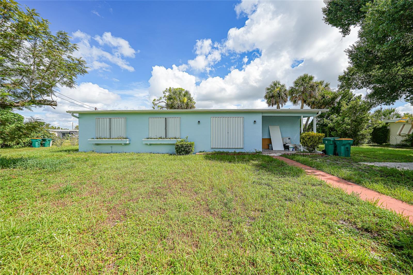 Welcome to this beautifully updated 3-bedroom, 2-bathroom home located in the heart of Port Charlotte. Recently renovated, the home features a newer roof (2022), updated electrical and wiring, fresh drywall and ceilings, new doors, and a freshly painted interior. The kitchen has been fully remodeled with new shaker-style cabinetry and finishes that blend style with functionality. The spacious interior includes open living and dining areas, plus an inside utility room for added convenience. Situated on an oversized lot with a private backyard feel, this home is perfect for year-round living or a seasonal retreat. Enjoy the nearby amenities—just a short walk to Lake Betty Park and Midway Park, or a quick drive to Port Charlotte Golf Club, boat ramps, shopping centers, restaurants, and schools. Move-in ready and close to everything, this home offers comfort, updates, and location all in one. Schedule your private showing today!