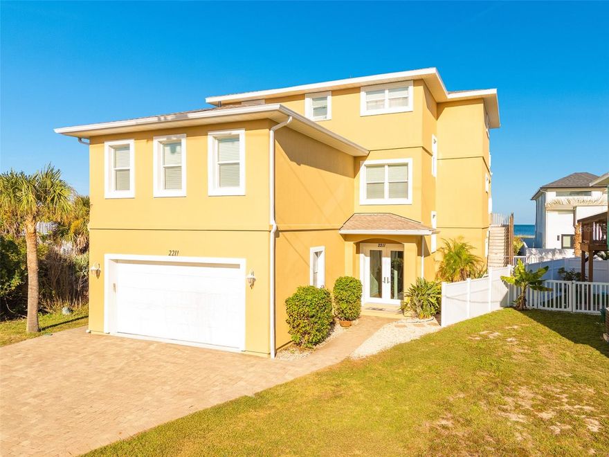 Experience refined coastal living at 2211 S Central Avenue, a custom five-bedroom, four-bath ocean-view residence designed for strength, elegance, and year-round serenity. Set along one of Florida’s most beautiful stretches of coastline, this three-story home offers sweeping Atlantic views from every level, where sunrises, sea breezes, and the sound of waves become part of daily life.

Built in 2010 and updated throughout, the home features solid block construction on the first two floors with EIFS insulation, a well-insulated framed third floor, and engineering rated for 140 mph wind load. Recent upgrades include a New Roof (2024), New Gutters & Soffit (2025), Updated Electrical Panel (2025), Three New AC Units, Two New 40-Gallon Water Heaters (2025), Fresh Exterior Paint (2025), and Hurricane-Rated Windows & Neuma Doors—all ensuring comfort and long-term reliability.

Inside, Neuma double doors open to a bright foyer with blonde wood flooring, crown molding, and an airy main level anchored by a gourmet kitchen. Solid wood cabinets, granite counters, stainless-steel appliances, and a center island create a warm and functional gathering space. French doors lead to a covered deck with ocean views. Two bedrooms and a full bathroom sit on this floor, with elevator access to all levels for effortless convenience.

The second floor offers another expansive living area with a full kitchen featuring white cabinetry, granite counters, stainless-steel appliances, and a large island. French doors open to an oceanfront balcony with panoramic shoreline views. This level also includes two ensuite bedrooms with walk-in closets, a spacious game room, and a second laundry area.

The top floor is an impressive private retreat. The primary suite features a sitting area with an electric fireplace, a personal kitchenette, custom office cabinetry, dark wood flooring, integrated ceiling speakers, and a private balcony overlooking the Atlantic. The spa-style bathroom includes a jetted soaking tub, tiled walk-in shower with dual showerheads, and a large walk-in closet.

Outside, the property offers low-maintenance landscaping, a paved driveway, vinyl fencing, stone pathways, and a two-car garage with non-slip flooring and laundry capabilities. Three ocean-view decks - two covered and one open-air provide year-round outdoor living. A drainage membrane system ensures water is properly directed away from the home.

Property Highlights
• 5 Bedrooms | 4 Bathrooms | 4,472 Sq. Ft. Heated
• Ocean Views from Every Level
• Two Full Kitchens + Primary Suite Kitchenette
• Elevator to All Floors
• Two Laundry Areas
• Game Room & Built-In Office
• Spa Bath with Jet Tub
• Surround Sound & Ceiling Speakers
• Three Ocean-View Decks
• Three New AC Units + Dual Water Heaters
• Engineered for 140 mph Wind Load

Professionally staged to reflect its coastal elegance, the home is offered fully furnished, with a complete furniture package available separately. Ideal as a primary residence, luxury vacation home, or multigenerational retreat, this exceptional property invites you to experience coastal living at its finest - where the ocean is more than a backdrop; it’s a way of life.