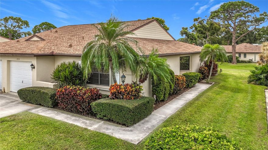 This 2-bedroom villa with a DEN and garage showcase vaulted ceilings, elegant staggered porcelain tile, and upscale furnishings.  Additional desirable features include an extensive view of the garden area and the close proximity to the pool.  UPDATED KITCHEN offers newer cabinets, stainless steel appliances, and diagonal tile flooring. Both bathrooms have been renovated with modern vanities, toilets, and flooring. PRIMARY BATH includes a beautifully updated walk-in shower with shampoo niche and the safety of a grab bar.  Enjoy peace of mind with recent upgrades: AC (2023), water heater (2020), roof (2022 - covered by HOA), newer interior doors, hurricane accordion shutters (front/back), clear panels (sides), and a garage door brace bar. The AIR CONDITIONED garage adds comfort and the Florida room is integrated into the living area for year-round use. There's also a private outdoor patio for grilling. Plenty of storage (deep hall closet) and parking (1-car garage + 3 spaces for guest parking). HOA covers roof, exterior pest control, Sentricon termite protection, painting, lawn care, and community pool. Vivienda offers a prime location near Sarasota Airport, IMG Academy, SCF, Publix, Target, Detwiler’s, library, restaurants, and the beaches of Bradenton & Anna Maria Island. Being sold As-Is.