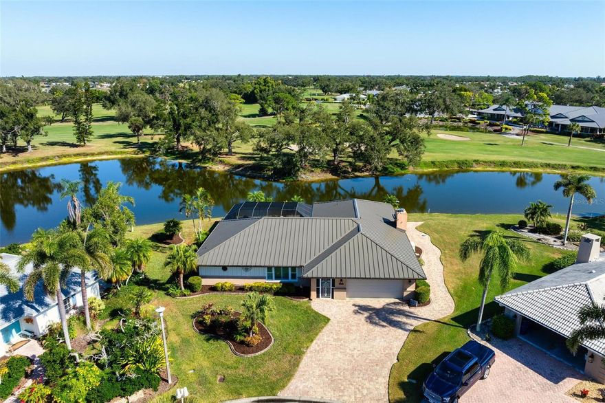 Set in the well-established and centrally located community of Jacaranda West, this updated 3-bedroom, 2-bath pool home enjoys a premium wraparound water and golf course setting with panoramic views of the signature 9th green. With over 180 feet of water frontage on more than a third of an acre, the property provides an exceptional natural backdrop where egrets, heron, cormorants, sandhill cranes, osprey, and even bald eagles are frequent visitors.
Thoughtfully upgraded outdoor spaces embrace the tropical Florida lifestyle, featuring a saltwater pool with PebbleTec finish, travertine decking, a ClearVue cage, high-output heater, separate spa, and a spacious seating area overlooking the serene landscape.
The home’s mechanical systems are in excellent condition, supported by a buried 250-gallon propane tank that feeds the whole-home generator, grill hookup, and poolside firepit table. Additional peace of mind comes from impact windows and doors, a storm-rated garage door, lanai shutters, third-nail reinforcement, and a 2024 standing-seam metal roof.
Inside, recent improvements and warm, inviting finishes create a space that truly feels like home. A vaulted great room with fireplace and a wall of pocketing sliders opens seamlessly to the pool area. The renovated kitchen features soft-close KraftMaid cabinetry, generous drawer banks, and under-cabinet lighting, while the primary bedroom includes its own mini-split AC for personalized comfort.
With low HOA fees, no CDD, both AC units replaced in 2025, added attic insulation, and a location just minutes from beaches, downtown Venice, Wellen Park, the Braves stadium, and everyday conveniences, this home offers a rare blend of quality, comfort, nature, and Florida living at its finest.