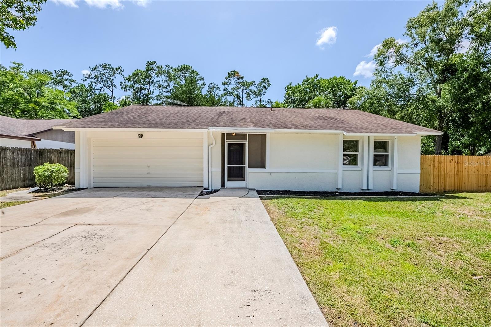 This beautifully renovated 3-bedroom, 2-bath home features fresh interior and exterior paint, brand-new LVP and carpet flooring, and stylish new fixtures throughout. The stunning kitchen boasts quartz countertops and all-new cabinetry, while both bathrooms offer updated vanities with quartz tops. Step outside to enjoy the sparkling pool with a screened enclosure—perfect for relaxing or entertaining. Move-in ready with upgrades inside and out!
