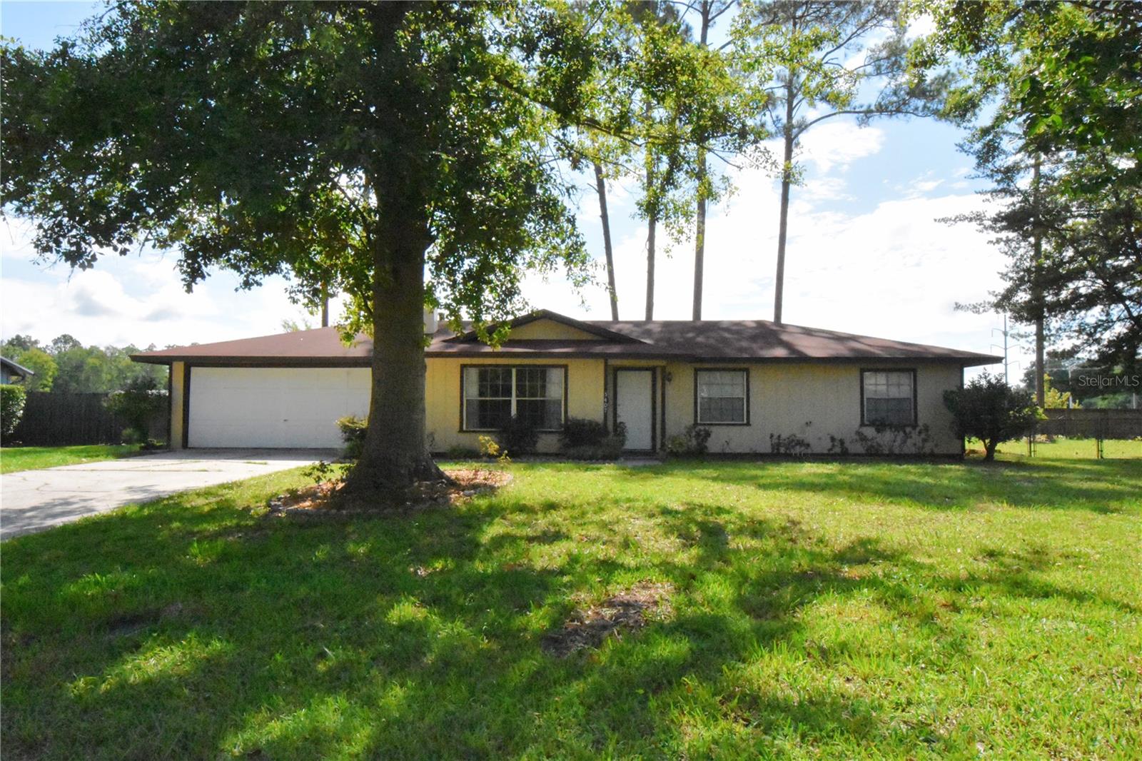 Well-kept home on a premium corner lot with large back yard in Northwood Pines! Located on a quiet back street with very minimum traffic providing privacy. NO HOA! Home has a newer roof, HVAC, & hot water heater. "Natural Gas" hot water heater, HVAC heat, and stove. Kitchen updated with Corian counter tops & newer appliances. Large screen room to enjoy your fruit trees, garden area, & landscape of your private back yard. Living room has a cozy warm feel with wood burning brick fireplace. Kitchen, living area, & dining room are in an open floor plan. There is good cabinet & storage space throughout the home. Large 2 car garage (25' deep X 22' wide). Shed 10' X 12'. Back yard is completely fenced with gates on both sides of the house. Including a large double gate to put a boat or camper in the back yard. Located in preferred NW Gainesville. Fiber Optics Available! A quick commute to UF & Santa Fe Colleges; Shands, North Florida, & VA Hospitals. Home is move in ready! A must see!