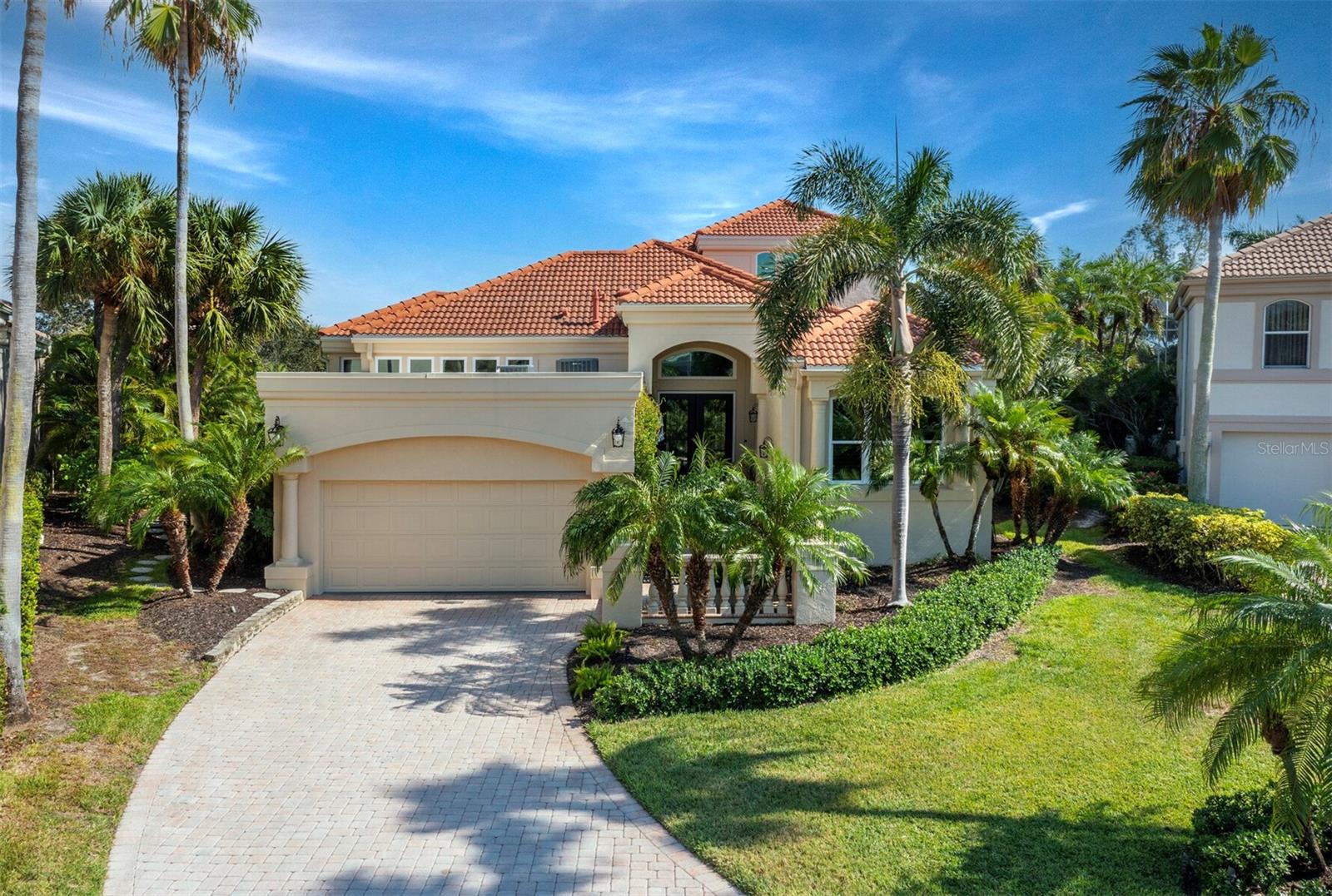 Revel in unparalleled luxury and comfort, as every detail was designed to elevate your lifestyle in this fully remodeled masterpiece nestled on one of the largest lots in the prestigious Queens Harbor neighborhood of Bay Isles. Set on hole #4 of the Harbourside Golf Course, the views are nothing short of spectacular – from the meticulously maintained course to the lush, rolling green fairways and tranquil lake, every glance offers a glimpse of paradise. Follow through the double glass door front entry, where the great room concept welcomes you with ceilings soaring over 10’ high and walls of glass that beckon in natural light, offering stunning vistas of the lush surroundings. The ambiance is one of elegance and sophistication, with every detail meticulously crafted to perfection. The heart of this home lies in its beautifully redone kitchen, where stone countertops and complementing cabinetry with glass panel accents create a culinary haven. Adorned with top-of-the-line stainless-steel appliances, including a gas cooktop and wine refrigerator, this kitchen is a chef's delight. Transom windows further illuminate the space, enhancing its warmth and charm. Retreat to the primary suite, where luxury meets tranquility. Featuring a sitting area and a wall of windows overlooking the golf course, this suite offers a serene escape from the everyday hustle and bustle. The primary bath is also fabulous, boasting dual vanities, a glass walk-in shower, and spa tub. Upstairs, a stunning office which can also be used as a 4th bedroom, is adorned with walls of windows plus an oversized rooftop terrace offer breathtaking two-story views of the golf course and lake. Whether you're working or simply unwinding, this space provides the perfect backdrop for inspiration and relaxation. The outdoor living spaces are equally impressive, with an expansive brick patio wrapping around the back of the home and leading to a private pool on the side. Complete with a spa, water feature, built-in grill and awnings for afternoon shade, this outdoor oasis is perfect for entertaining or simply soaking up the sun in style. Additional features include; high impact hurricane glass, new 2024 A/C units, Generac generator and the roof replaced in 2019. As a resident of Queens Harbor, you have access to a full, exciting menu of amenities as well as all the exclusive Gulf-front benefits of the Bay Isles Beach Club. Deepwater slips for lease or purchase and membership in Longboat Key Golf & Tennis Country Club are available.