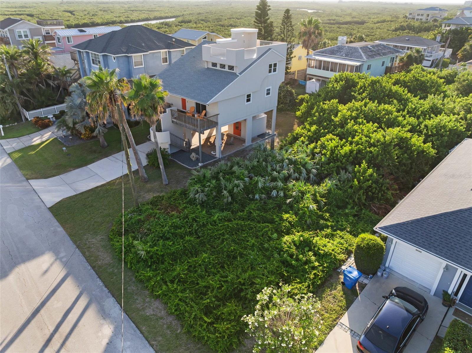 Build your dream home here and breathtaking ocean and wetland views could be yours. Located on a quiet, well-established street in highly desirable Bethune Beach, this 50' x 100' lot is just steps from one of New Smyrna Beach’s most secluded and pristine stretches of shoreline—a no-drive beach beloved for its natural beauty and peaceful atmosphere.
This is truly beachside living at its best. Enjoy quick access to the ocean, lagoon, JB's Fishcamp, and the Canaveral National Seashore, with its boat launch and endless outdoor adventures just minutes away. Whether you envision a modern coastal retreat or a timeless seaside escape, this is your chance to create something special in a setting that simply doesn't get any better than this.
Interested in creating a truly spectacular generational haven?
Combine this lot with the adjacent property at 895 Catfish Avenue—a striking midcentury modern residence offering 1,724 sq ft under air / 2,873 sq ft total. (MLS# NS1085280) This rare double-lot opportunity provides the space, flexibility, and location to build a legacy property just steps from the beach.