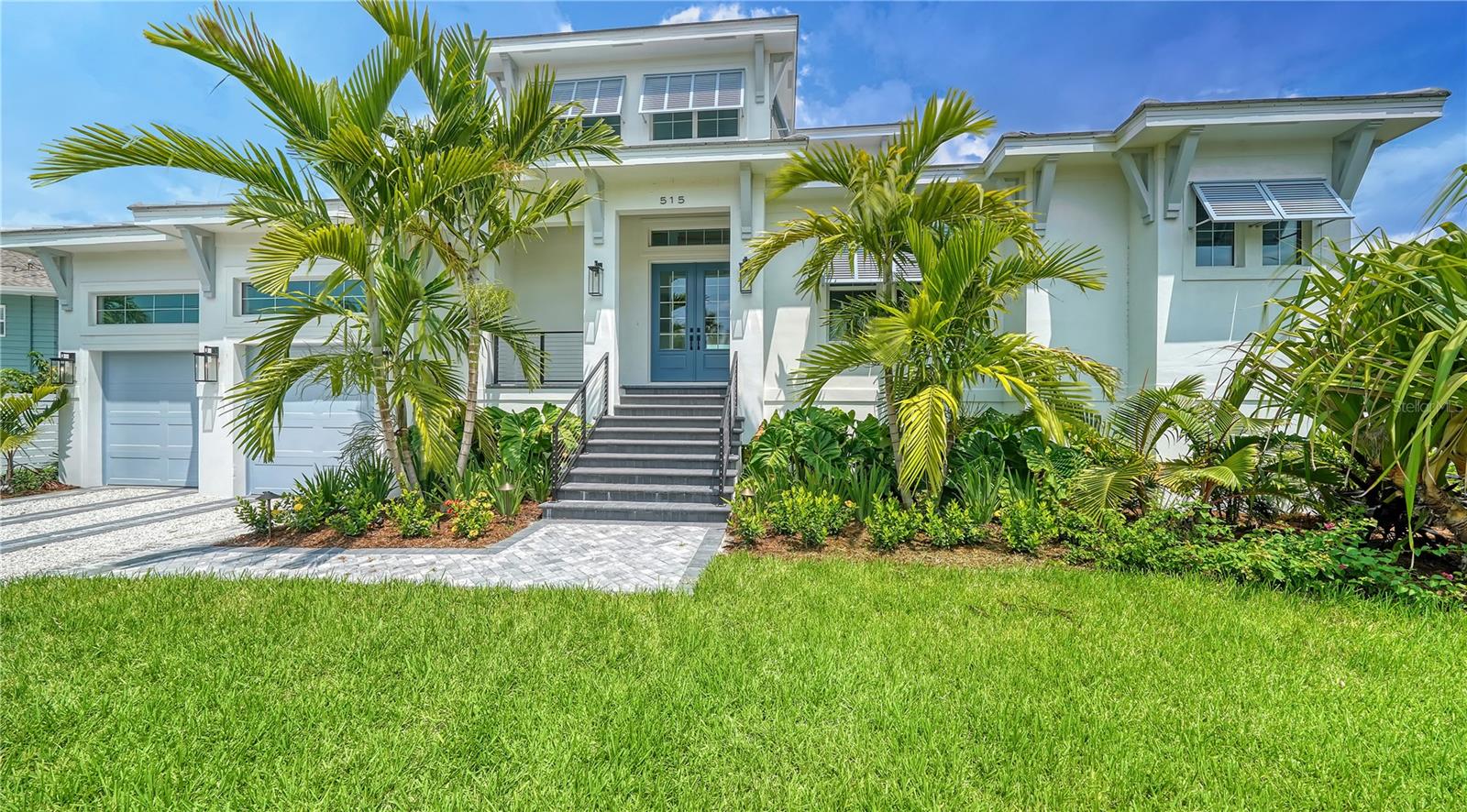 One or more photo(s) has been virtually staged. PRICE REDUCTION! This is the one you've been searching for... newly completed Luxury Custom Coastal Contemporary Waterfront pool home on Siesta Key built by Nutter Construction. As you enter through the double front doors, the finest quality and workmanship are evident throughout this two-story gem intended to exceed your expectations. This beautiful open concept home features 3 bedrooms, 3.5 bathrooms, a great room with 10' beamed ceilings, an office/den, and a bonus room upstairs for family and friends. The thoughtfully designed first floor owners suite offers 2 walk in closets and an incredible bath with a free standing design tub, double vanities, rain head shower and frameless glass enclosure. The open concept chef's kitchen has top of the line Thermador appliances including a 42" side by side refrigerator/freezer, a 36" pro 6 burner stainless steel range, a microwave drawer and a large walk-in pantry. To the right of the kitchen, you will find the spacious great room featuring 10' beamed ceilings, an electric fireplace, a beverage center and sliding glass doors that open up to your lovely covered lanai and pool area. The office, utility room and pool bath are also found on the main living level. As you make your way upstairs, you will find the bonus "club" room which features 9' ceilings and a beverage center. Also on the second level is another ensuite bedroom with a walk-in closet and an additional bedroom with the 3rd bath just outside the door. Additional features include a heated saltwater pool, naturally aged Niebla Gray European Oak wood floors in all rooms except the utility and bathrooms, quartz counter tops in kitchen and master, 4 panel solid core interior doors with Schlage door hardware, low-e impact windows and sliding doors, custom cabinetry, tankless water heater, 2 car garage, wood ceilings on front porch and covered lanai, and an irrigation system.