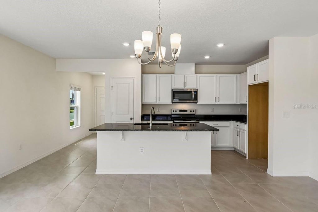 Photo of 627 Meadows Edge Place, Lake Wales, FL 33859 (MLS # O6443298)