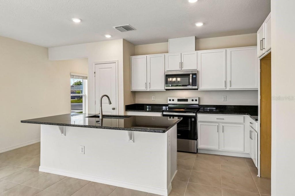 Photo of 627 Meadows Edge Place, Lake Wales, FL 33859 (MLS # O6443298)