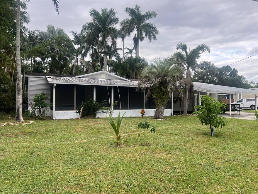 Beautifully remodeled 3 bedroom 2 bath mobile home on just over 1/3 acre in Taylor Creek Isles. This home has a front
porch and back porch, a drive-through carport/garage and a 14x20 bonus room/mancave with pull-down stairs to the right of the garage. The
back yard boasts of beautiful palm trees, including queen palms.