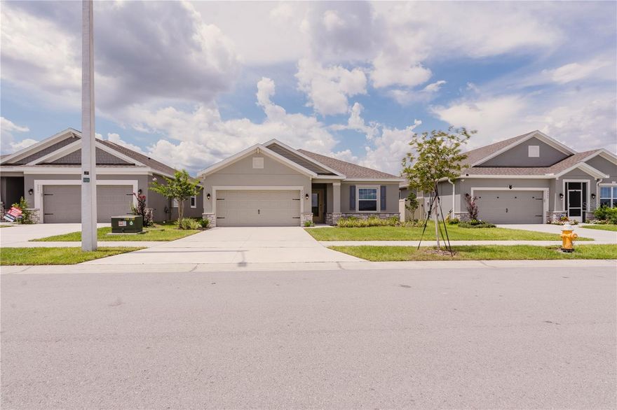 This stunning new construction features a charming exterior with elegant brick stone accents. Inside, enjoy a bright, open-concept layout with soaring 9’4” ceilings, a spacious great room, and generously sized secondary bedrooms. The beautifully appointed kitchen offers quartz countertops, 42” cabinets with crown molding, stainless steel appliances, and a large island overlooking the dining area and great room—ideal for entertaining and everyday living. The home includes 3 comfortable bedrooms and 2 stylish bathrooms, highlighted by an impressive owner’s suite complete with a luxurious walk-in tiled shower and walk-in closet. Relax and entertain outdoors year-round on the large covered lanai. Additional features include granite countertops throughout, an indoor laundry room, and peace of mind with a 10-Year Structural Warranty, Builder’s Warranty, and Manufacturer’s Warranties included. Located in the Eden Hills community of Lake Alfred, FL—just minutes from I-4 and conveniently close to shopping, restaurants, and more.