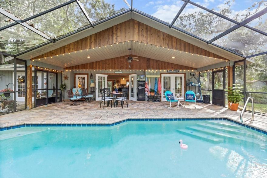 Discover the perfect blend of country living and city convenience in this 3-bedroom, 2-bath retreat on 2.5 acres (MOL) shaded by majestic oaks. Designed for relaxation, this property features a spacious 33x35 lanai and sparkling pool for effortless indoor/outdoor living. Bring your hobbies and animals — no deed restrictions! Already equipped with a chicken coop, a small greenhouse, a storage shed, a covered/electric workshop, and RV parking with water & electric hookups. Inside, natural light pours through French doors, highlighting a versatile layout with a home office/guest room that includes a fold-down Murphy bed for guests, updated step-in shower, and a kitchen/dining area with a rustic barn door pantry. Rare rough-sawn cedar (pest resistant) siding. All this is just 2.5 miles from shopping, dining, and everyday conveniences — and only minutes to saltwater and freshwater boat ramps, crystal clear springs, and the 46-mile Withlacoochee Trail. Whether you’re seeking a private residence, a weekend getaway, or an income-producing Airbnb, this one-of-a-kind property delivers it all.Schedule your showing today! (HVAC 2022, Lanai screening 2024, Electrical panel 2019.)