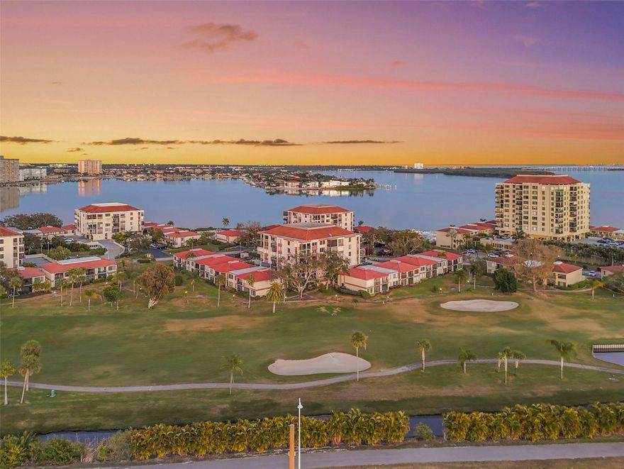 Enjoy the best of golf and waterfront living in this beautiful, top-floor 2-bedroom, 2-bathroom condo located in the sought-after Palma Del Mar community in St. Petersburg. This light-filled residence offers breathtaking views of the golf course and the Gulf, with an abundance of natural light pouring in through the many windows and sliding glass doors. Inside, the condo features wood-look vinyl flooring throughout the main living areas and fresh interior paint, creating a bright and welcoming atmosphere. The kitchen is well-appointed with brand-new stainless steel appliances (2/1), ample cabinetry, and a separate pantry area for additional storage. The open layout allows the stunning views to take center stage from the living and dining spaces. The true highlight of this home is the private balcony, where you can relax and take in sweeping golf course and Gulf views. Motorized hurricane shutters provide added peace of mind and convenience. The primary bedroom shares the same incredible views and features plush carpeting, a walk-in closet, and a private ensuite bathroom with a large vanity and a step-in glass-enclosed shower. The second bedroom also enjoys a beautiful view and features wood-look vinyl flooring. The second bathroom has been updated with a new vanity, mirror, and light fixture, and includes a tub/shower combination. Additional conveniences include an in-unit washer and dryer and a covered, assigned parking space. Palma Del Mar offers exceptional amenities, including a recreational clubhouse, heated swimming pool and spa, fishing pier, kayak dock and launch, and direct water access for kayaking and paddleboarding. Ideally located just 5 minutes from St. Pete Beach and close to local dining, shopping, and entertainment, this condo offers the perfect combination of location, views, and low-maintenance coastal living. Don’t miss your opportunity to own a piece of paradise in one of St. Petersburg’s most desirable waterfront communities. Schedule your showing today!