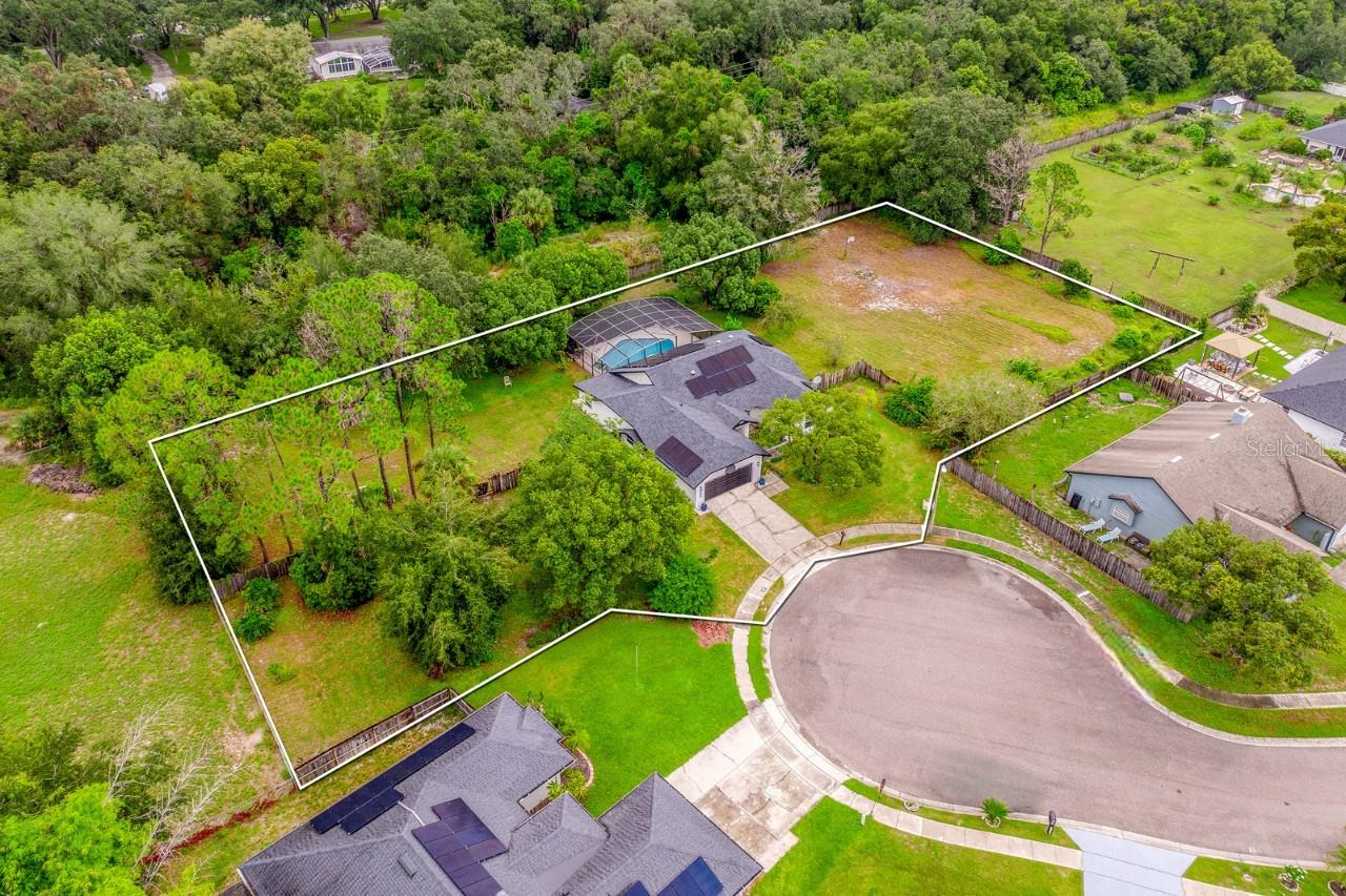 Seller may consider buyer concessions if made in an offer ~ Welcome to Sunrise Estates and your opportunity to own a truly unique property in the heart of Winter Springs! Sitting on just **OVER AN ACRE** at the end of a quiet **CUL-DE-SAC**, this single story **POOL HOME** combines privacy, upgrades, and location in a way that is hard to find. Major improvements bring peace of mind, starting with a NEWER ROOF (2021), UPDATED A/C (2022), NEW WATER HEATER (2022), WATER SOFTENER SYSTEM (2022) and DOUBLE PANE WINDOWS (2022). Fresh EXTERIOR PAINT and a SOLAR SYSTEM keep the home looking great and your utility bills low. Inside you will be delighted to find many updates, along with vaulted ceilings, and HARDWOOD, wood laminate and tile floors that flow throughout the functional layout. The foyer is framed by the living and dining areas, with the living room offering a cozy fireplace and direct access to the lanai. The UPDATED KITCHEN features sleek BOSCH STAINLESS STEEL APPLIANCES, granite countertops, complementary tiled backsplash, abundant storage, and glass inset doors that open directly to the lanai – making INDOOR/OUTDOOR LIVING a breeze! On one side of the home three guest bedrooms share a fully updated bath complete with exterior access, and on the opposite side your expansive PRIMARY SUITE feels like a retreat that delivers custom blinds, a WALK-IN CLOSET and a private en-suite bath with a dual sink vanity, SOAKING TUB and separate tiled shower. A flexible bonus space connects to your suite – ideal for a sitting room, home office, home gym or nursery, with direct access to the backyard for plenty of natural light. Step outside and into your own private oasis – a COVERED LANAI and expansive deck overlooks the sparkling POOL and SPA, all SCREENED and surrounded by mature trees that create a private, tranquil setting. With all the space you could ask for and a fully FENCED YARD, there is plenty of room for play, gardening, or simply enjoying the outdoors! Irrigation is handled by a private well, while the home connects to public water for convenience. Residents will appreciate the LOW HOA, easy access to Sunrise Community Park and the location couldn't be better. You are just minutes from TOP-RATED SCHOOLS, shopping, dining, neighboring Oviedo and major roadways like SR 417, Red Bug Lake Rd, Tuskawilla Rd and 426. Don’t miss the rare chance to own over an acre in Winter Springs with an updated pool home at the center of it all. The private setting, thoughtful upgrades, and unbeatable location make this one a MUST-SEE! Call today to schedule a tour!