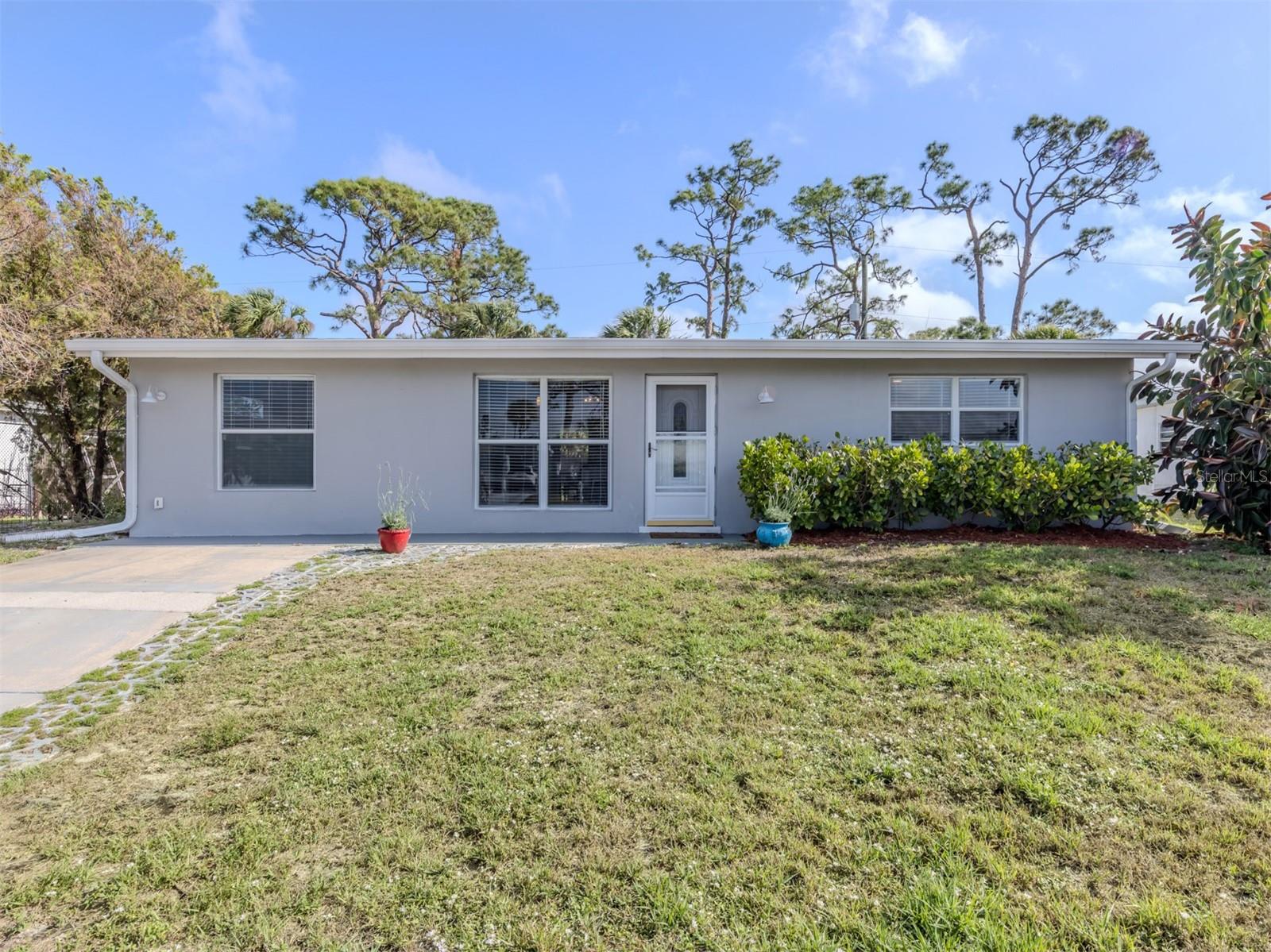 ***BACK ON THE MARKET!! BUYERS FINANCING FELL THROUGH!!***** This beautifully maintained split 1,187-square-foot home offers a blend of modern updates and functional design with public water and sewer! The spacious floor plan features a welcoming great room design ideal for entertaining and everyday living. The home features stylish tile and laminate flooring throughout, adding durability and charm throughout. At the heart of the home lies a large, updated kitchen, complete with solid wood cabinetry, sleek granite countertops, a convenient breakfast bar and stainless-steel appliances for the home chef. Sliding glass doors from the kitchen lead directly to the expansive screened lanai, enhancing indoor-outdoor living. Comfort is ensured year-round with two air-conditioning units installed in 2010, while a new roof in 2022 and water heater in 2018, ensuring efficiency and peace of mind. The primary suite serves as a private retreat, offering two generous primary closets and a private en suite with a walk-in shower. On the opposite side of the home, two additional spacious bedrooms and the second full bath provide ample space for family, guests or a home office. Go outside to enjoy the large, screened lanai, complete with convenient half-bath access, or relax on the concrete patio with ample space for a hot tub. The fenced backyard, featuring double gate access, offers privacy and versatility for outdoor activities. Just minutes from dining, medical facilities, shopping, top-rated schools, Warm Mineral Springs, Cool Today Park with Braves spring training and U.S. 41.