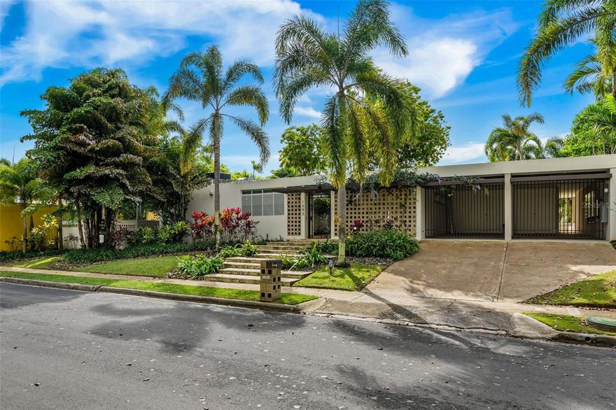 This stunning single-story residence offers a seamless blend of elegance, comfort, and nature. From the moment you enter the property, you are welcomed by the soothing sound of a refined water fountain set in a beautifully landscaped exterior courtyard, creating a tranquil transition into the home. This courtyard connects directly to the interior dining area, allowing natural light, greenery, and outdoor serenity to flow effortlessly indoors.

Upon entry, the brilliance of the marble floors reflects the abundant natural light guiding your view toward the breathtaking backyard. The outdoor area is truly captivating, featuring three terraces, a swimming pool, a small basketball court, and an additional detached structure complete with a full bathroom and shower; ideal for a home office, studio, guest suite, or flexible living space.

The residence offers four bedrooms and a thoughtfully designed layout. As you enter the bedroom wing, you’ll find a convenient office area. The first bedroom is an en-suite, followed by two additional bedrooms—one with direct access to the hallway bathroom. The master bedroom is a private retreat featuring a spacious walk-in closet, a modern open shower, and a separate, independent bathroom.

The living areas include a formal living room and a family room, both equipped with security doors that open to the exterior, enhancing the connection to the lush backyard and creating a peaceful, indoor-outdoor living experience.

The kitchen flows into an open informal dining area and connects seamlessly to the formal dining room, ideal for both everyday living and entertaining. The home also features a generously sized laundry room, a guest powder room, and an additional half bathroom for added convenience.

Adjacent to the kitchen terrace, you’ll find a temperature-controlled wine cellar with capacity for up to 250 bottles, offering direct access to the carport. The carport is equipped with three Tesla batteries, 85 fully paid solar panels, and an additional diesel generator, providing exceptional energy efficiency, sustainability, and peace of mind. Its also provides extra storage for convenience.

This extraordinary property offers refined living, modern comforts, and a serene connection to nature—all on one level which is rare to find.