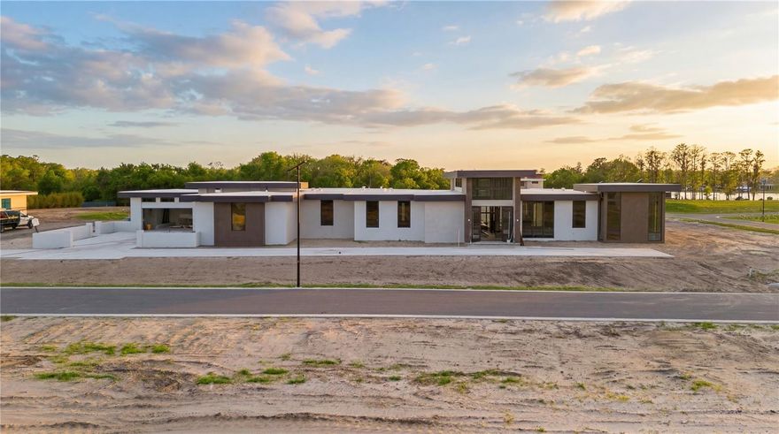 Under Construction. The Darsh model at Odessa Preserve embodies a seamless fusion of contemporary elegance and functional design, tailored for discerning homeowners seeking luxury, practicality and security. Spanning approximately 9,311 square feet with 5,788 dedicated to living space, this single-story residence offers four spacious en-suite bedrooms and five baths, thoughtfully arranged to provide privacy and comfort. The guest bedroom has a private access and private garden and could act as second primary or mother-in-law suite. The open-concept layout features a grand foyer that leads into expansive living and dining areas, ideal for intimate family gatherings and larger social events. The state-of-the-art kitchen is equipped with high-end premium appliances and custom cabinetry that serves as heart of the home. A spacious prep kitchen, private herb garden, wine room, bonus room and dedicated den offer additional spaces for work or leisure. Architectural details such as high ceilings, large high-impact windows and clean lines enhance the home's airy ambiance, allowing natural light to flood the interiors. The primary suite serves as a private retreat, boasting a spa-inspired bath, private garden, outdoor shower and generous walk-in closet. Outdoor living is equally prioritized, with a covered patio and resort-style pool, spa and fire pit that seamlessly extends the indoor living space for alfresco dining or relaxation. Built with energy efficiency in mind, the Darsh is pre-wired for security and home automation and includes high-performance insulation and energy-efficient appliances. Additionally, a whole-house generator ensures uninterrupted comfort and security during power outages. In the exclusive Odessa Preserve, residents enjoy access to top-rated schools, upscale shopping and fine dining, all in a secure, gated community. The Darsh model stands as a testament to refined living, combining architectural brilliance with modern amenities. It's more than a home, it's a lifestyle choice for those seeking unparalleled comfort and style.