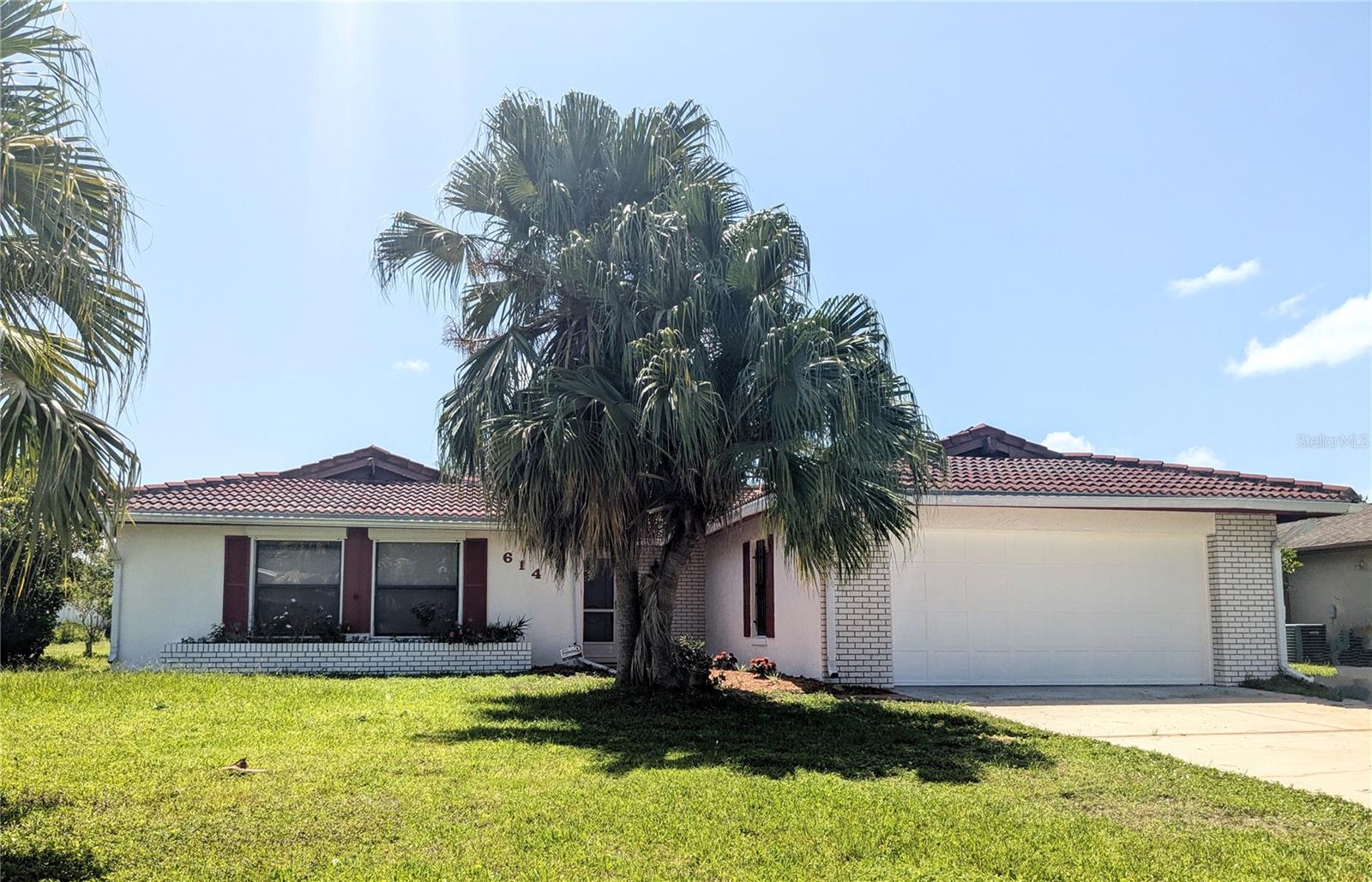 Cute 3 bedroom, freshly painted interior and exterior located in the desirable 34759 zip code. Enter the front door to a bright airy space, with double sliding glass doors to enjoy the outdoors. Sliding glass doors open to a covered back patio for outdoor dining and enjoying the space. To the right enter the Large Den and eat in kitchen with another set of sliding glass doors. The kitchen has lot's of counter space and cabinets. Eat in space right by the sliding glass doors.  Off the den is the inside Laundry room/half bath combo. On the left side of the front entry is the bedrooms. A large primary bedroom with another set of sliding glass doors and a huge walk in closet and it's own full bath with shower. All the floors are ceramic tile, no dirty carpets in this house.  beautiful tiled roof, huge back yard, certainly enough run around space, plenty of room for a large inground pool and fruit trees. The home is located close to restaurants, shopping and the theme parks. Ideal location. Walking distance to the community playground and park. Air conditioner is just about 2 years old. The home is sure to please.