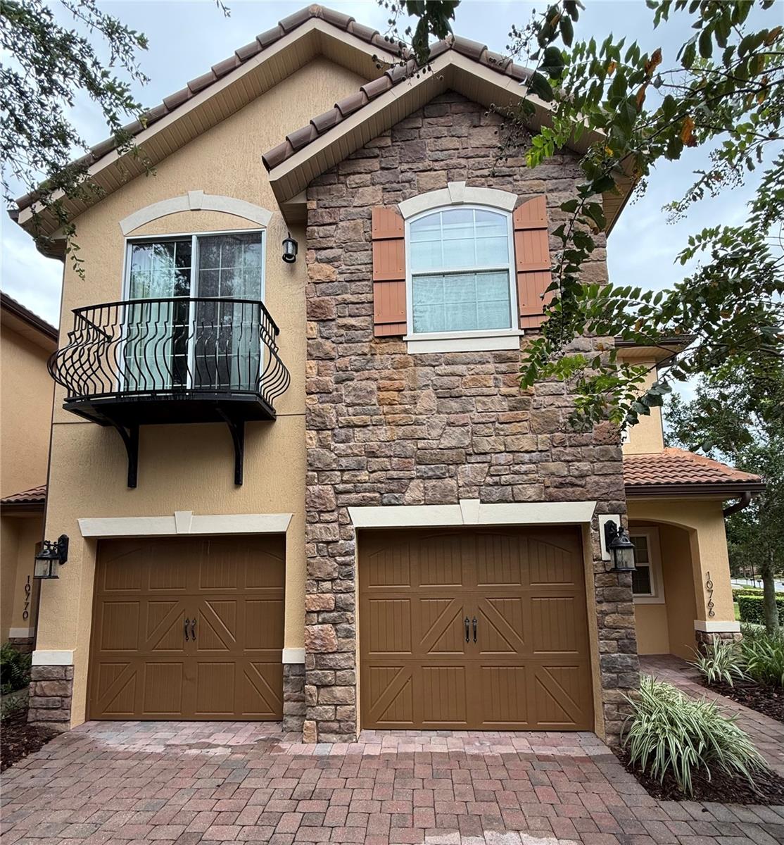 Welcome to the 4 Bedroom, 3.5 Bath Corner Unit Townhome in Eagle Creek in Lake Nona, Orlando, FL. This stunning townhouse offers a luxurious lifestyle with its spacious bedrooms, all carpeted for your comfort, and 3.5 bathrooms featuring garden tubs and walk-in showers. The master suite is located upstairs and comes with a private balcony. The home boasts unique fixtures, wood floors, and a tray ceiling in the master suite that adds an elegant touch. The kitchen is equipped with stainless steel appliances and the home includes a washer/dryer. The large screened-in patio offers beautiful water views, perfect for relaxation. The townhome also includes a 2-car garage with a paver driveway. The community amenities are top-notch, including a pool, tennis courts, a fitness center, and a playground. The corner unit location provides additional privacy. The community is also guarded with a gate for added security. The location is unbeatable, being close to Nemours Children's Hospital and Boxi Park. This townhome is a perfect blend of comfort, luxury, and convenience.