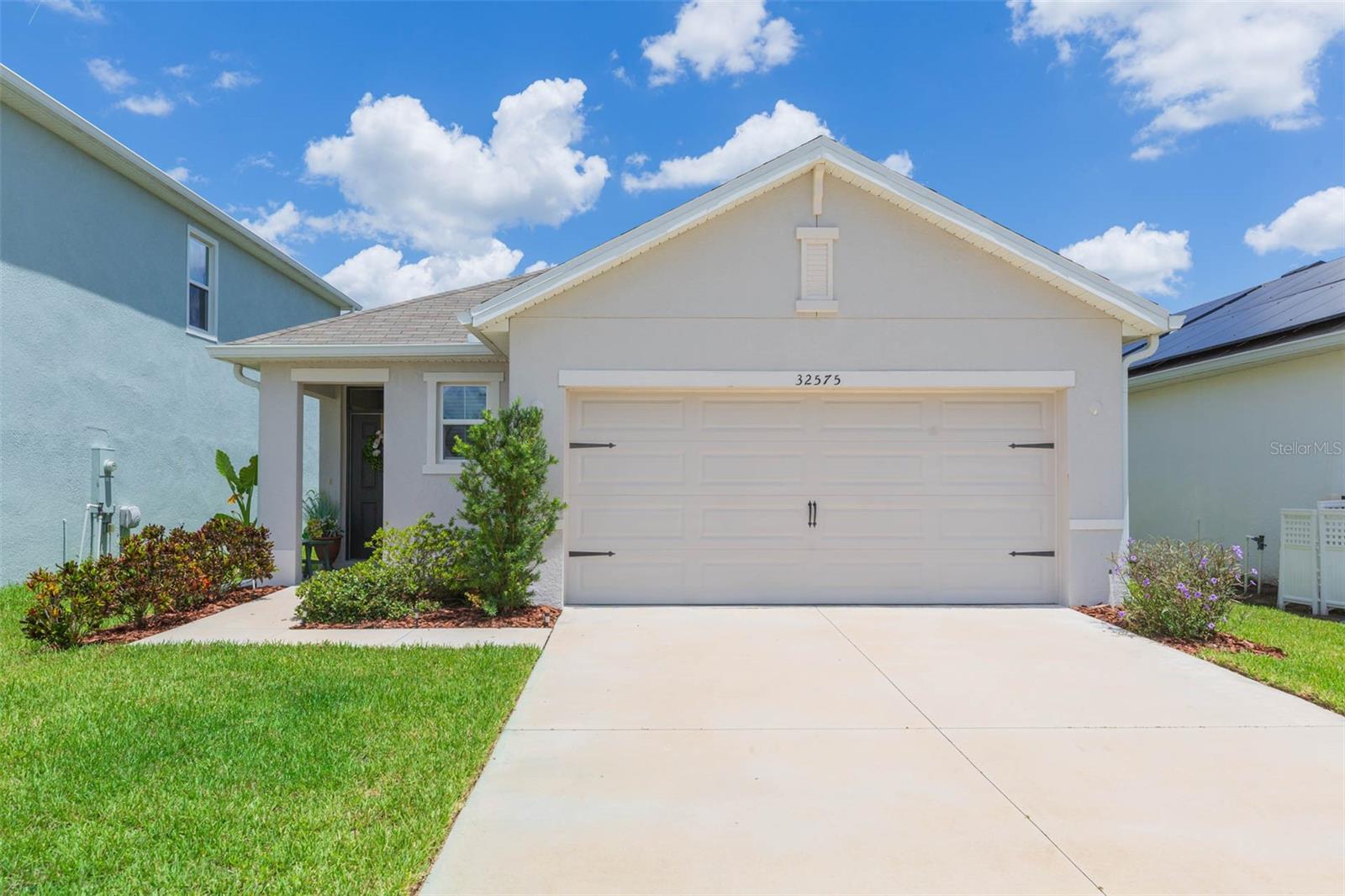 Welcome to this charming, well-designed home in the highly sought-after Union Park community in Wesley Chapel, the area's most desirable "smart home" neighborhood. The moment you walk in, you'll notice the thoughtful use of space and the ideal layout without any wasted space. As you enter, the light gray tile flows from the front entry to the double sliding doors to the lanai. This home features three spacious bedrooms, providing ample room for everyone to comfortably enjoy their own space. The inviting entry leads into a generously sized dining room, ideal for family meals, holiday gatherings, or celebrating special occasions. From there, step into the large, open kitchen, complete with modern gray wood cabinets, granite countertops, and upgraded stainless steel appliances. Large pantry is adjacent and provides additional storage to the multiple cabinets in the kitchen. The long kitchen peninsula provides the perfect spot for casual family discussions or a quick meal before you head out the door. The expansive family room is bathed in natural light, thanks to double sliders that open up to the oversized lanai and beautifully landscaped backyard so relaxing mornings and evenings are a daily event to look forward to. The master suite is a true retreat, tucked away in the back corner of the home. A king-sized bed fits comfortably in this spacious room and the ensuite bathroom offers lots of countertops, a walk-in shower, and a very large walk-in closet. The two guest bedrooms are spacious and are thoughtfully separated from the primary bedroom for privacy. The guest bathroom is shared by these two bedrooms and is easily accessible to the family room. Convenience is key with an interior laundry room and the included washer and dryer. A two-car garage provides lots of additional storage space. This home is in pristine condition and still feels “brand new”. With the exceptional price point, you'll be pleasantly surprised by how much room and value you’re getting. As part of the Union Park community, you’ll enjoy incredible amenities, including two sparkling pools, both a lap pool and a resort-style pool, along with a clubhouse, fitness center, multi-purpose sports courts, a tot lot, miles of nature trails, a splash pad, dog parks, and even pickleball courts which are coming soon. Additionally, Union Park Charter Academy is right outside the community, and top-rated schools are just a short distance away. This wonderful community is close to Wiregrass Mall, the Outlet Mall and the Grove Mall. Three hospitals are within a few miles and I75, 301, I275 and downtown Tampa are easily accessible. Moffitt, University of South Florida and Haley VA Hospital are just a short drive away. This home offers a great combination of space, value, and access to fantastic amenities, making it an ideal choice for anyone looking to settle into a wonderful, family-friendly neighborhood. Union Park provides multitudes of activities and social experiences to enhance your lifestyle. Love where you live!