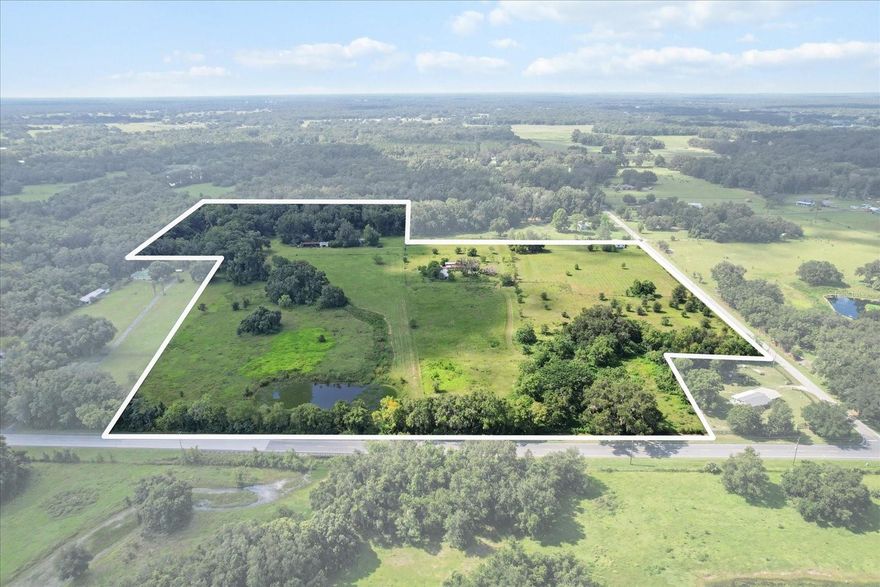 Extraordinary multi-generational 29.87 acre property including 3 homesites + large barn with stables. There are 2 mobiles, each with newer metal roof. Both of these homes could be beautiful with some work. The doublewide is a 3/2, and sits right on CR 625. The single wide sits back in a quiet glade, where the deer come with their babies every year. It has a metal garage building with roll up door, huge covered tractor port. There is a barn with tack room and bathroom in the center of the property. It has several interior stalls, plenty of storage, and it's own septic and well + electric. The old cracker house is falling apart, but was lovely at one time. It lies right on 48, next to the pond. So whether you rehab them, rent them, or sell 2 of the parcels, you've got great options here. Dream big, because the existing infrastructure is here. A creek runs thru the East side of the land, ending in a pond on the NE corner. Bring your horses, goats, chickens, pigs + donkeys! The wooded area has orange, walnut, pecan, and tangerine trees. Total of 4 wells(1 is commercial), 4 septic tanks. Fenced and cross fenced. Roughly 1.5 mi to I75.