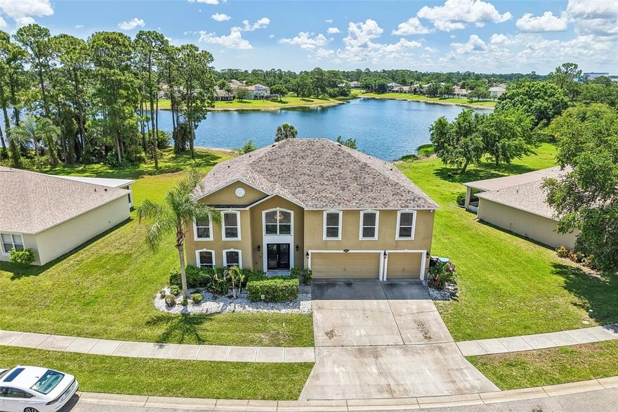 Spacious 6-bedroom, 4.5-bath lakefront home located in the desirable Bayside Lakes area of Palm Bay. This property offers an impressive floor plan, a large lot, and beautiful lake views from the backyard, creating a peaceful setting with excellent outdoor appeal.

Major updates have already been completed, including a roof that is approximately 3 years old, two newer high-efficiency Daikin FIT HVAC systems installed in April 2025 (3-ton and 4-ton units), and a newer A.O. Smith 80-gallon Hybrid Electric Heat Pump water heater manufactured in 2023. These upgraded systems were designed to provide improved energy efficiency, increased comfort, quieter operation, and enhanced hot water capacity for larger households.

The property also includes a newer GM Ultium PowerUp+ Level 2 electric vehicle charging station professionally installed at the home, offering convenient high-speed EV charging capability with up to 19.2 kW capacity. In addition, the home features a professionally installed, commercial-grade high-definition security camera system by Digital Guards Security Systems, using premium Hikvision surveillance equipment with a 16-channel monitoring setup and multiple ultra-high-definition cameras positioned throughout the property for enhanced security, remote monitoring, and full-property coverage.

The home does need cosmetic updates such as paint, flooring, kitchen, and bathroom renovations, giving the next owner the opportunity to customize the property and add significant value.

Located in a growing Palm Bay community near shopping, schools, parks, dining, and major roadways, this home is ideal for buyers looking for space, value, and long-term potential. Don’t miss the opportunity to make this spacious lakefront home your own.