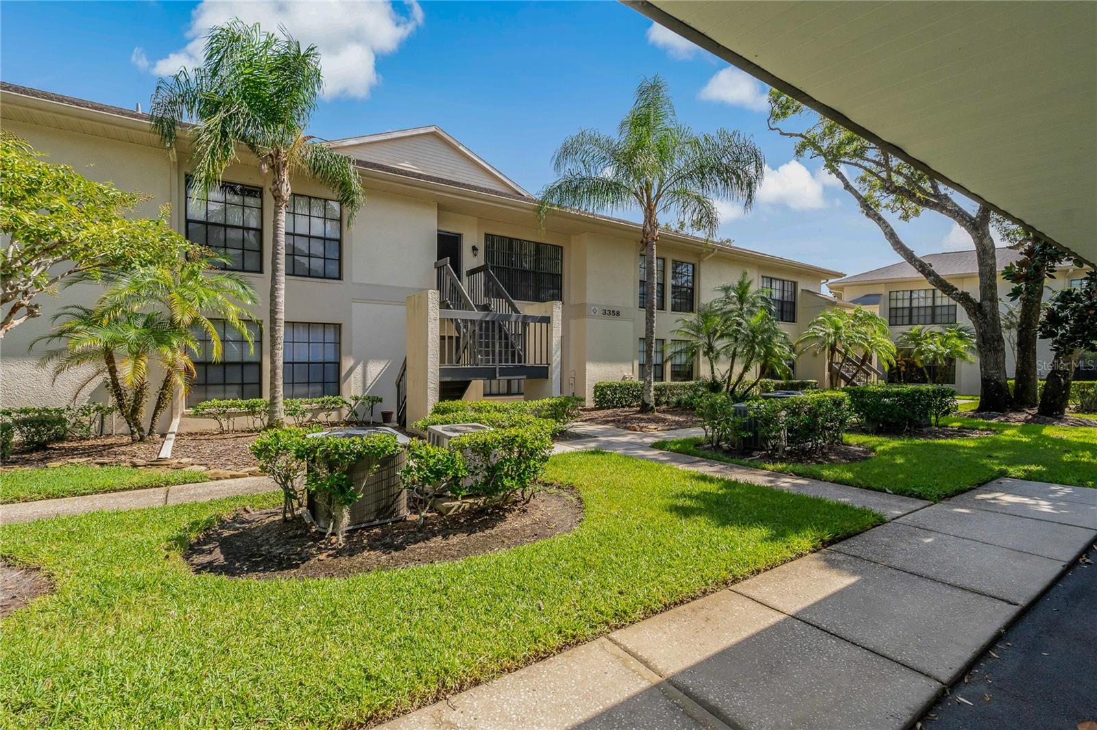 Gated community of Farrell Park located in Ridgemoor, the heart of Palm Harbor! Fabulous location, surrounded by nature and 4 public golf courses within minutes of this beautiful condo. This 2 bedroom, 2 bath condo has an amazing water view of the serene pond with no rear neighbors and not facing the parking lot! Your attention will be captured by how well maintained and how clean this condo has been taken care of. Rarely do you find a split bedroom floor plan with BOTH bedrooms being equal in size, approximately 12x15 in size and both have walk-in closets! You will love the spacious living room / dining room combo that is 16x22 and is wide open to the kitchen and provides the wonderful water view! You will not find carpet here – making it easy to keep it super clean! Enjoy the maintenance free lifestyle and take in all the outdoor activities from the walking & biking trails, tennis and basketball courts, picnic area, playground, to John Chestnut Park or relax in your heated community pool all year around! A truly wonderful community of all ages and pet friendly as well! Walking distance (less than 1 mile) to Publix, several restaurants and other services that make this condo centrally and conveniently located for your everyday needs!