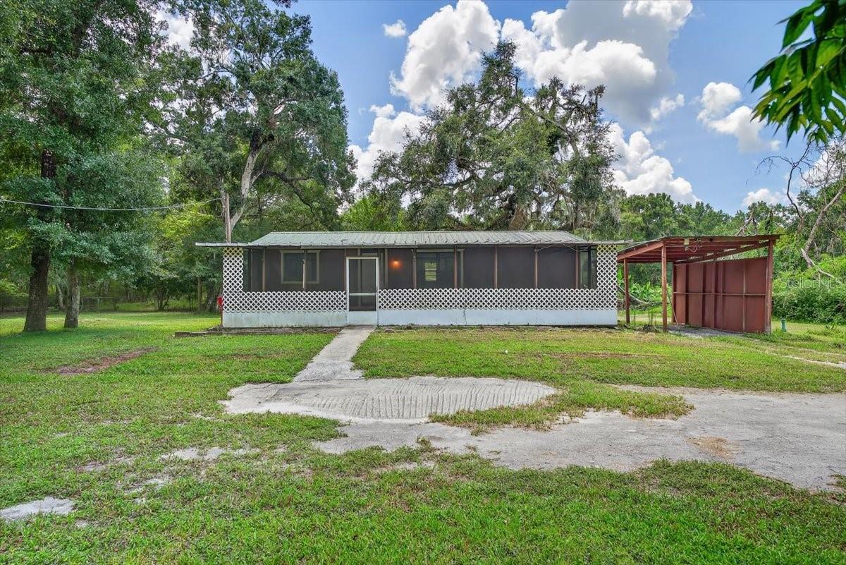 WOW! Spacious 2 bedroom/2bathroom manufactured home with a detached carport and HUGE screened-in front porch situated on a whopping 4.55 acres of land- zoned AG. With lots of love, this home can be custom updated and made perfect for you. Vaulted ceilings and plenty of windows open up and brighten the place. Both bedrooms have an attached bathroom. Bring all your pets and toys to enjoy the Florida country style living while still being only a 5-10 minute drive to town for convenience! More entertainment in Tampa and Orlando both only an hour away. Currently only window/wall ac units being used but central ductwork is in place. Lage barn in the back needs renovation/repair. Cash only! Great opportunity to create your own homestead or simply live a more private and free lifestyle. Schedule a viewing to see this property now!