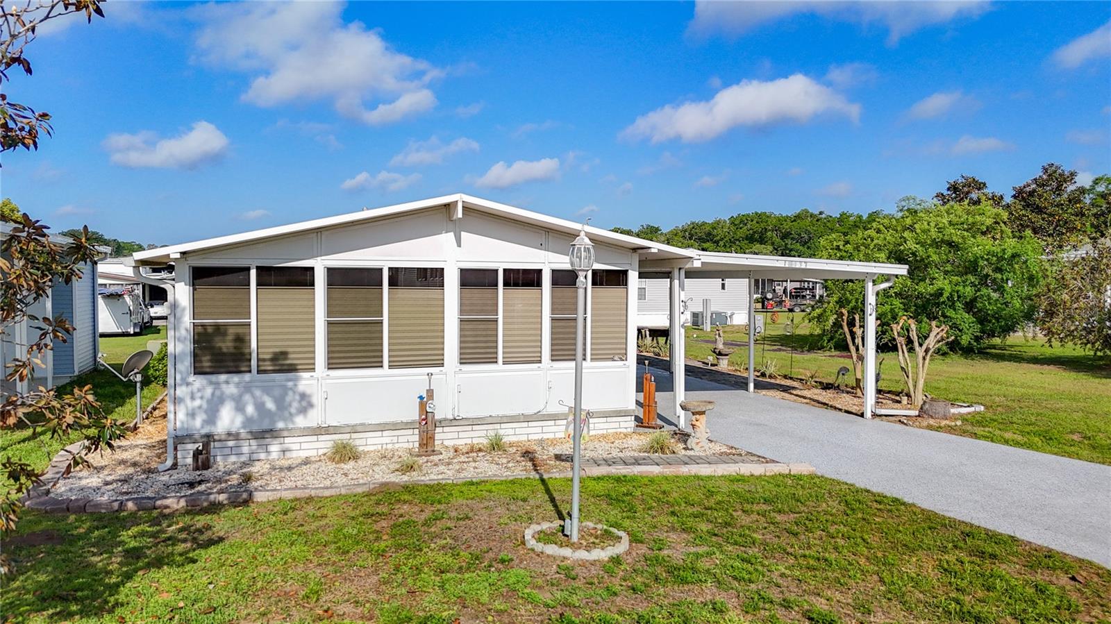 Amazing opportunity to live in the desirable 55+ gated community of Country Aire Manor! This move-in ready home offers 2 bedrooms, 2 baths with a spacious addition that is currently the 3rd bedroom or perfect for an office or den. As you approach you will notice the extended carport with plenty of room for parking and a lovely epoxy finish. The paver walk-way will lead to the 10x16 shed equipped with electric and a wall AC that is a perfect workshop. A new roof is to be installed on this shed. There is an additional shed that is a great storage addition. Step inside to the open floor plan. The spacious kitchen offers ample space for all your cooking needs and features nice cabinets, granite counters and a center island with granite and additional cabinets, tile backsplash, pantry with pull-out drawers, newer range, new dishwasher, an eat-in area with a pass-through window to the large lanai. The master bedroom features new laminate flooring, new windows and an en-suite for convenience. The 2nd bedroom is roomy in size with new windows and blinds. The addition (3rd bedroom/office) offers a wall AC. The laundry closet includes a newer washer and dryer. Enjoy your morning coffee or relax and unwind in the expansive lanai with glass windows and decorative wood slat wall. Metal roof was installed in 2017. LOW HOA FEE, NO CDD FEES. Country Aire Manor is conveniently located right off Highway 98, you’ll have easy access to both Dade City, Zephyrhills and Lakeland. This gated 55+ gated community features fantastic amenities, including a heated swimming pool, WIFI, cable, picnic areas, 2 Golf Practice Tees, Horseshoe, Pickle Ball, shuffleboard courts and more- all perfect for socializing and relaxation. Additionally, your monthly HOA fees cover water, sewer, trash, and common area maintenance.
Most furniture and contents are included. Seller will be removing personal items and possibly a few items. Golf cart is negotiable separate from the sale of the home.