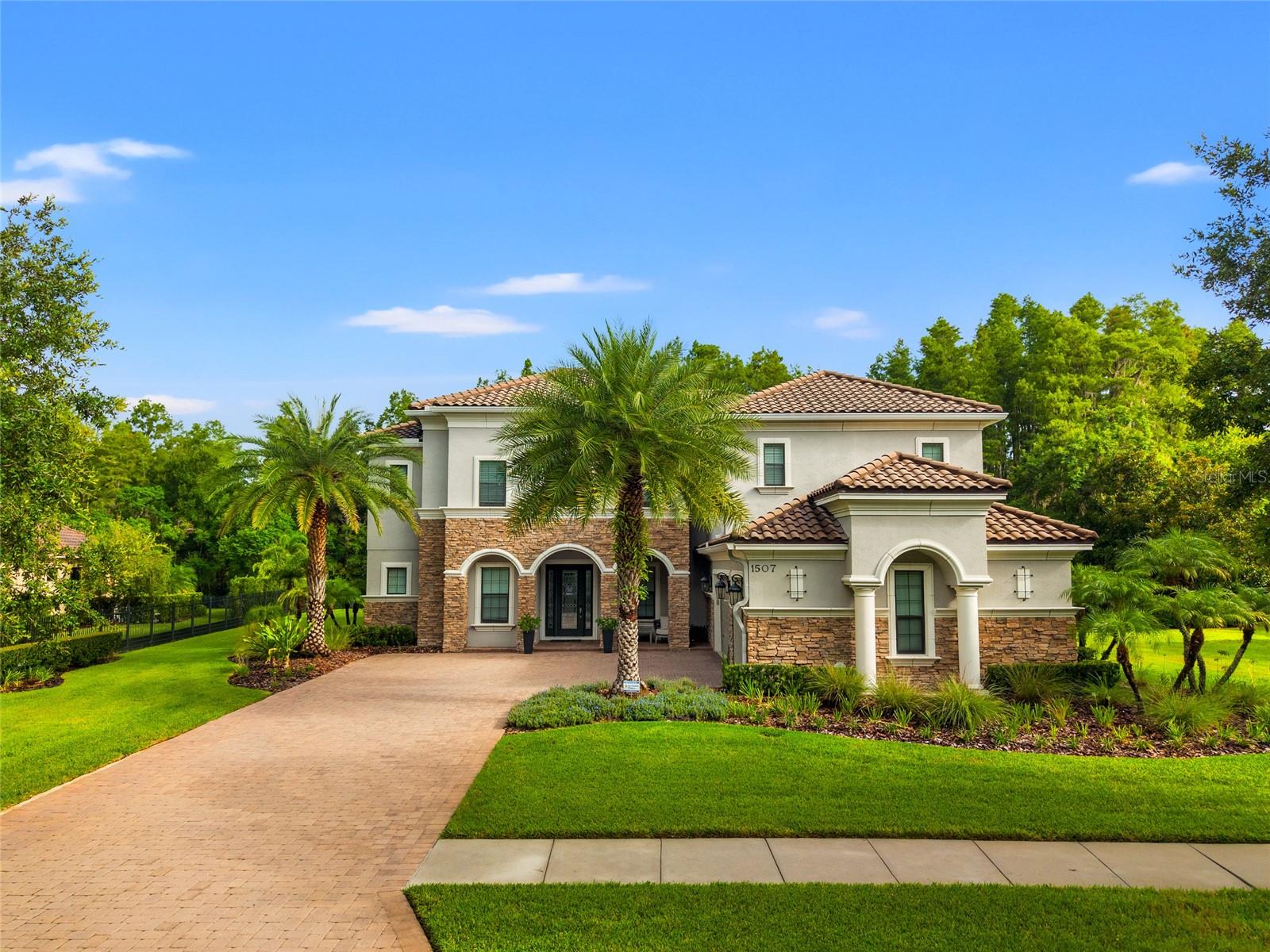 Under contract-accepting backup offers. Welcome Home! This exquisite home in the exclusive gated community of Ladera, where luxury meets comfort on a private 0.61-acre conservation lot. Zoned for A-rated Steinbrenner High and just minutes from the Veterans Expressway, this 5,412 sq ft estate offers an incredible lifestyle both inside and out.
Step through the front door and you’re greeted by wide-plank engineered wood floors that flow throughout the home. Off the foyer, a dedicated office with tray ceiling offers a quiet place to work. The formal dining room is spacious, with its own storage closet, perfect for hosting dinner parties and holidays.
The heart of the home is the chef’s kitchen, featuring double islands with sinks and disposals, GE Profile appliances, a gas cooktop with pot filler, double ovens, microwave, refrigerator, large walk-in pantry, wet bar, and a convenient drop zone. It opens to a large family room, pre-wired for surround sound and filled with natural light from oversized sliders that lead to the lanai.
Step outside and you’ll feel like you’re on vacation. The custom saltwater pool and spa feature a sun shelf, gas heater, Wi-Fi automation, and a Nebula lighting system built into the pool cage. The outdoor kitchen is fully equipped with DCS appliances, including a gas grill with rotisserie, dual-tap kegerator, fridge, ice maker, and a cement tile backsplash. A Valor gas fireplace adds ambiance, while wide-span panoramic screens frame peaceful conservation views. There’s even a turf play area, multiple ceiling fans, and a large storage closet for all your outdoor gear.
Back inside, a full pool bathroom features large porcelain tile, a towel closet, and a spacious walk-in shower. One of the five bedrooms is set up as a home gym with rubber flooring (equipment optional), while the others feature walk-in California Closets. Upstairs, enjoy a game room with a large wet bar, sink, and wine fridge, plus a separate media room already pre-wired for theater surround sound.
The owner’s suite is a retreat of its own with a tray ceiling, dual California Closets, a separate linen closet, and a spa-like bath complete with rain shower, handheld spray, showerhead, shower bench, and oversized porcelain tile.
The oversized laundry room offers GE washer/dryer on pedestals, a deep utility sink, and custom mudroom storage. The 3.5-car garage includes a water softener hookup, gas heater, and full-size fridge option, along with plenty of room for storage or toys. Even the driveway has been widened with pavers for extra space and style.
Smart features include Wi-Fi patio audio, automated sprinkler system, spotlights, surround sound wiring, and remote pool controls, Invisible pet fence system.
This home is move-in ready, packed with upgrades, and built for the way you want to live. Come experience the perfect blend of elegance, function, and fun.